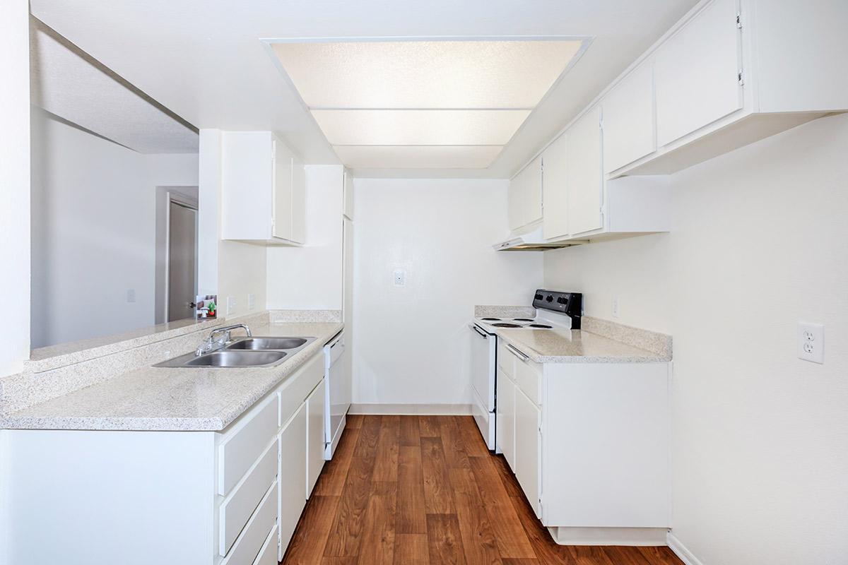 Kitchen with white appliances and cabinets