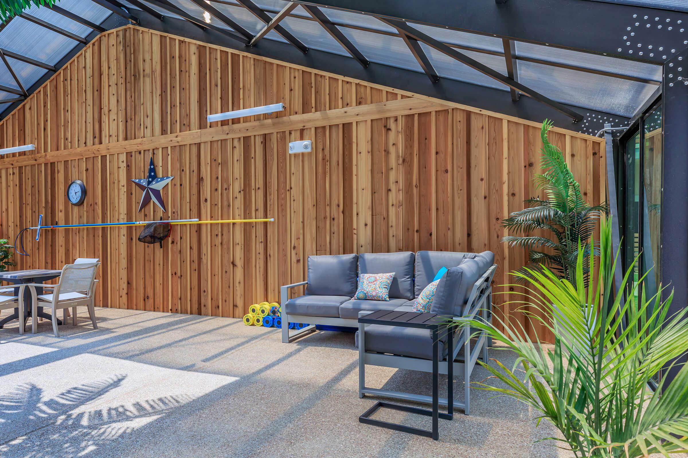 a group of people sitting around a wooden fence