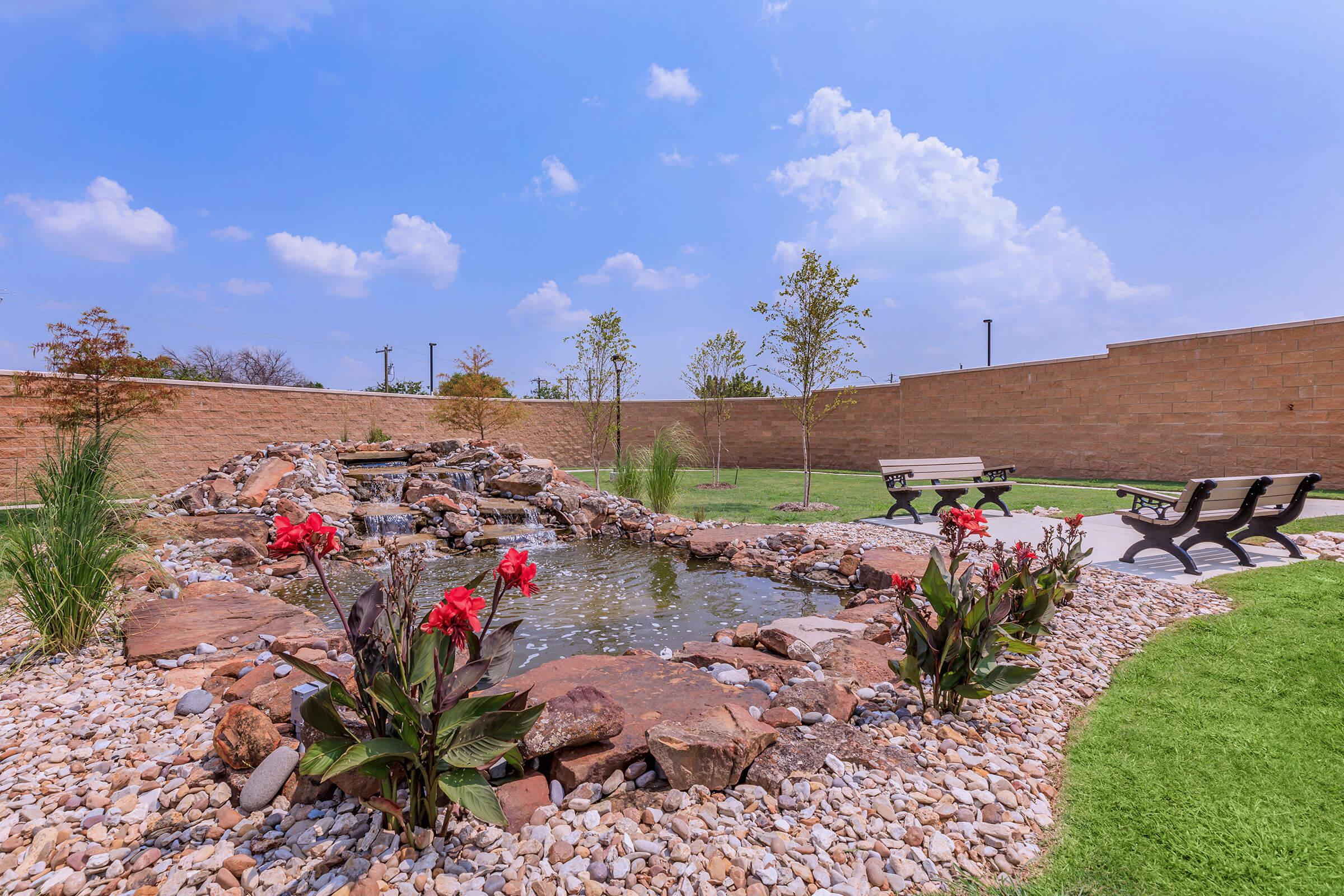 a garden with water in the background