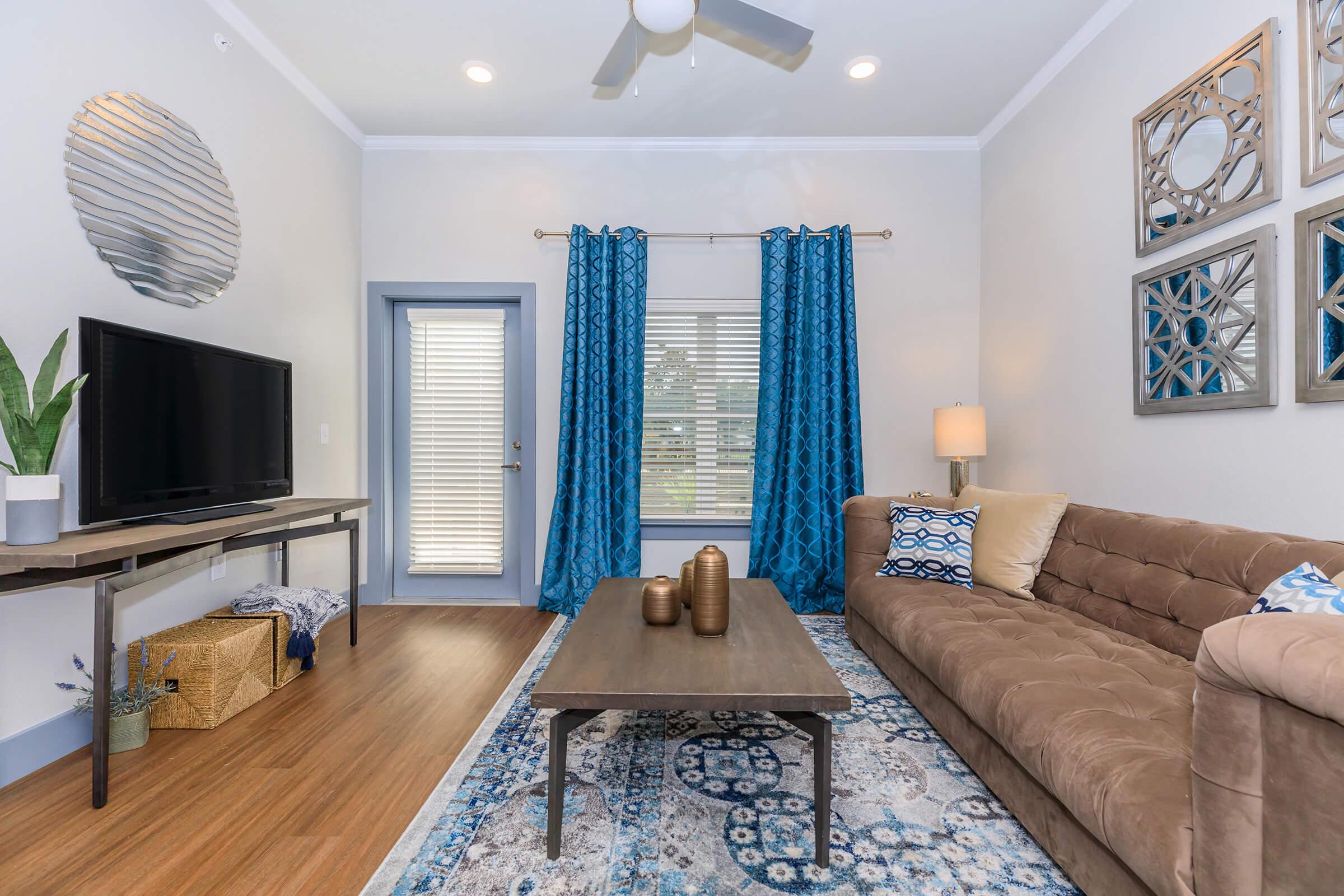 a living room filled with furniture and a large window