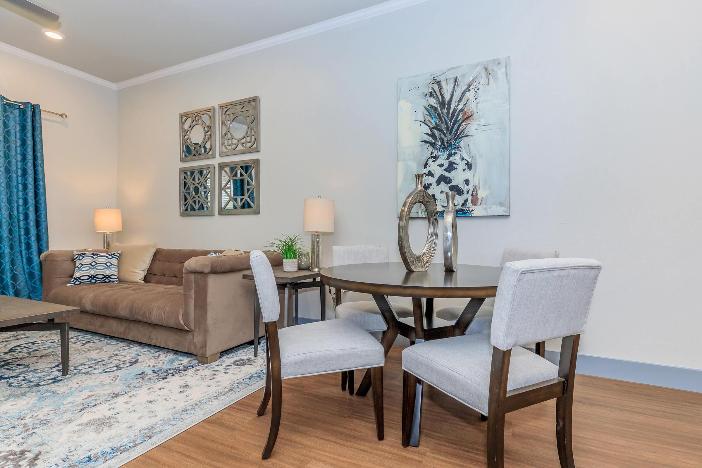 a living room filled with furniture and a table