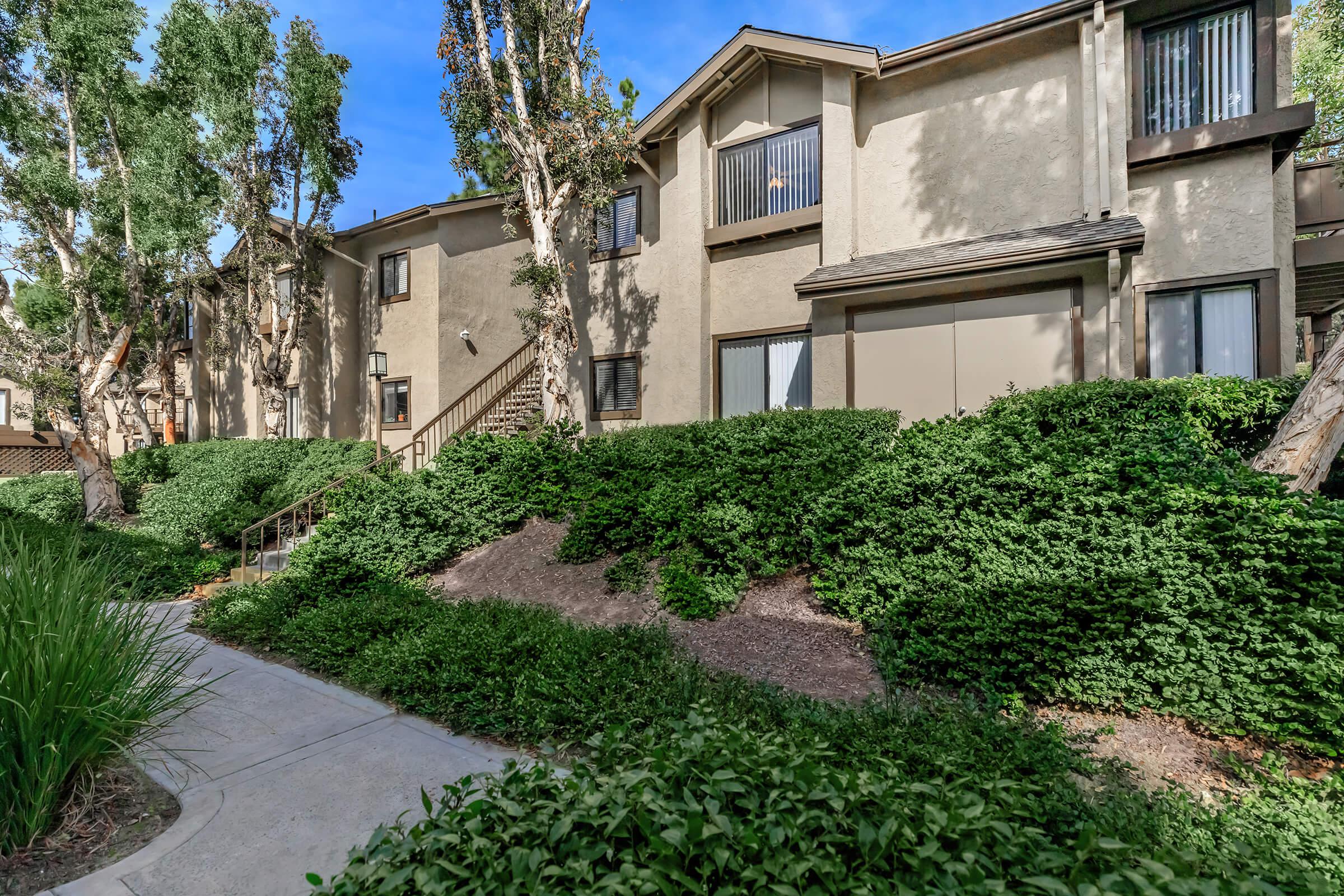 Spring Lakes Apartment Homes community building with green bushes