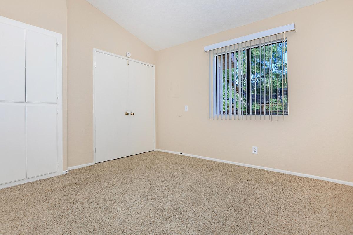 Bedroom with closed closet doors