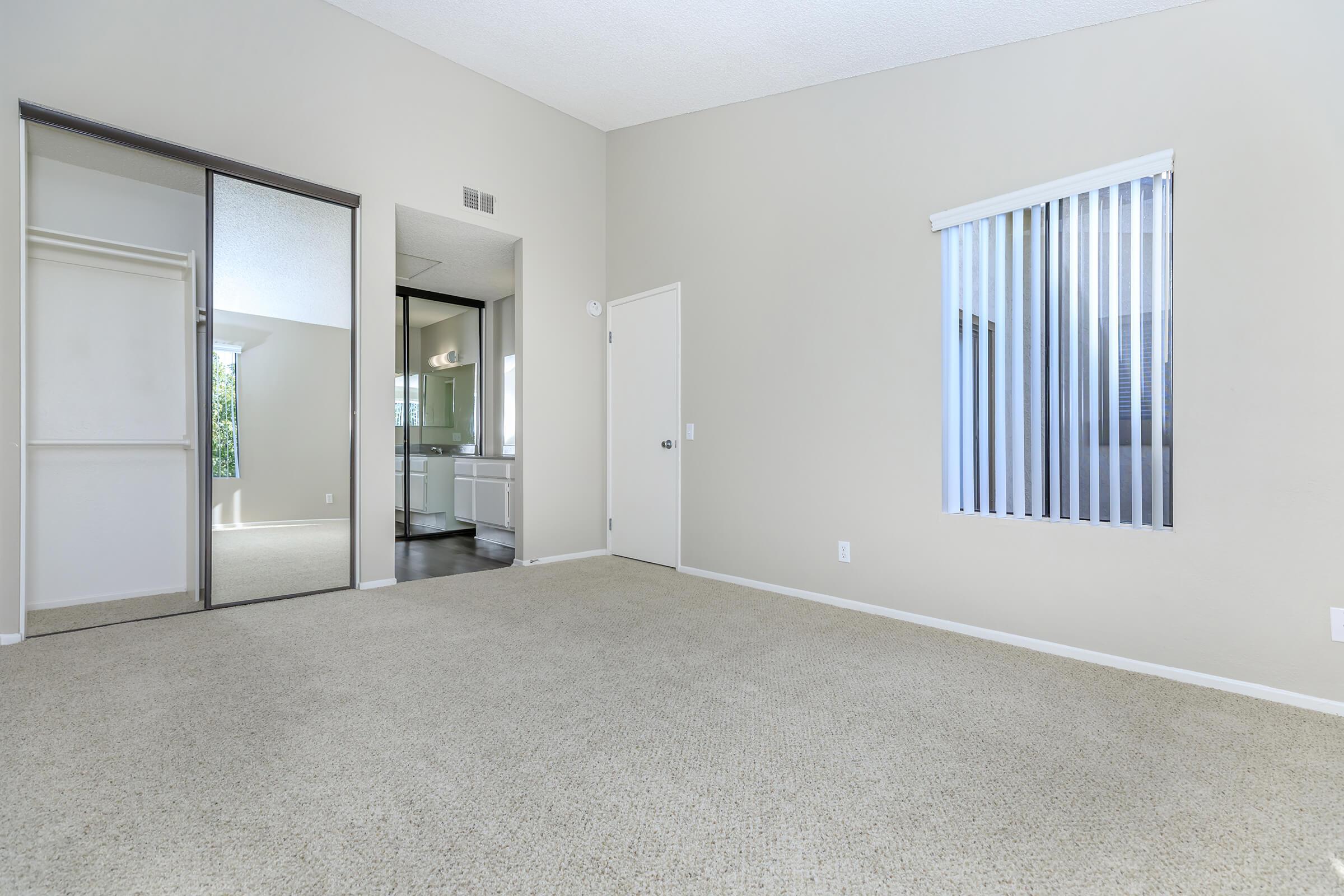 Bedroom with open mirror glass sliding closet doors