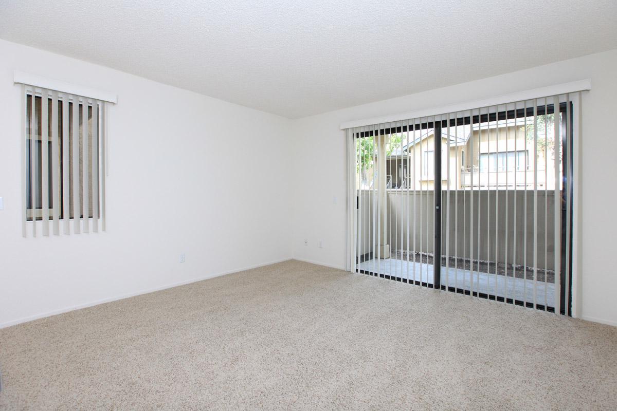 Carpeted living room with sliding glass doors