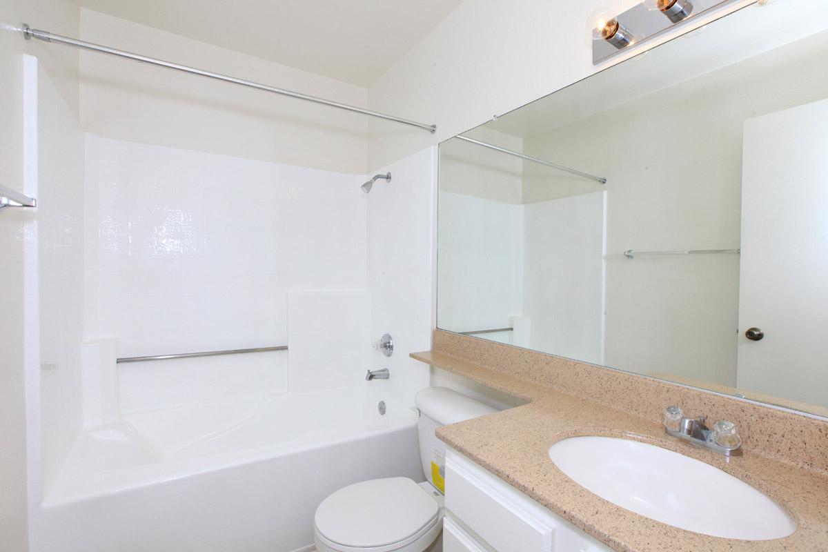 Unfurnished bathroom with white cabinets