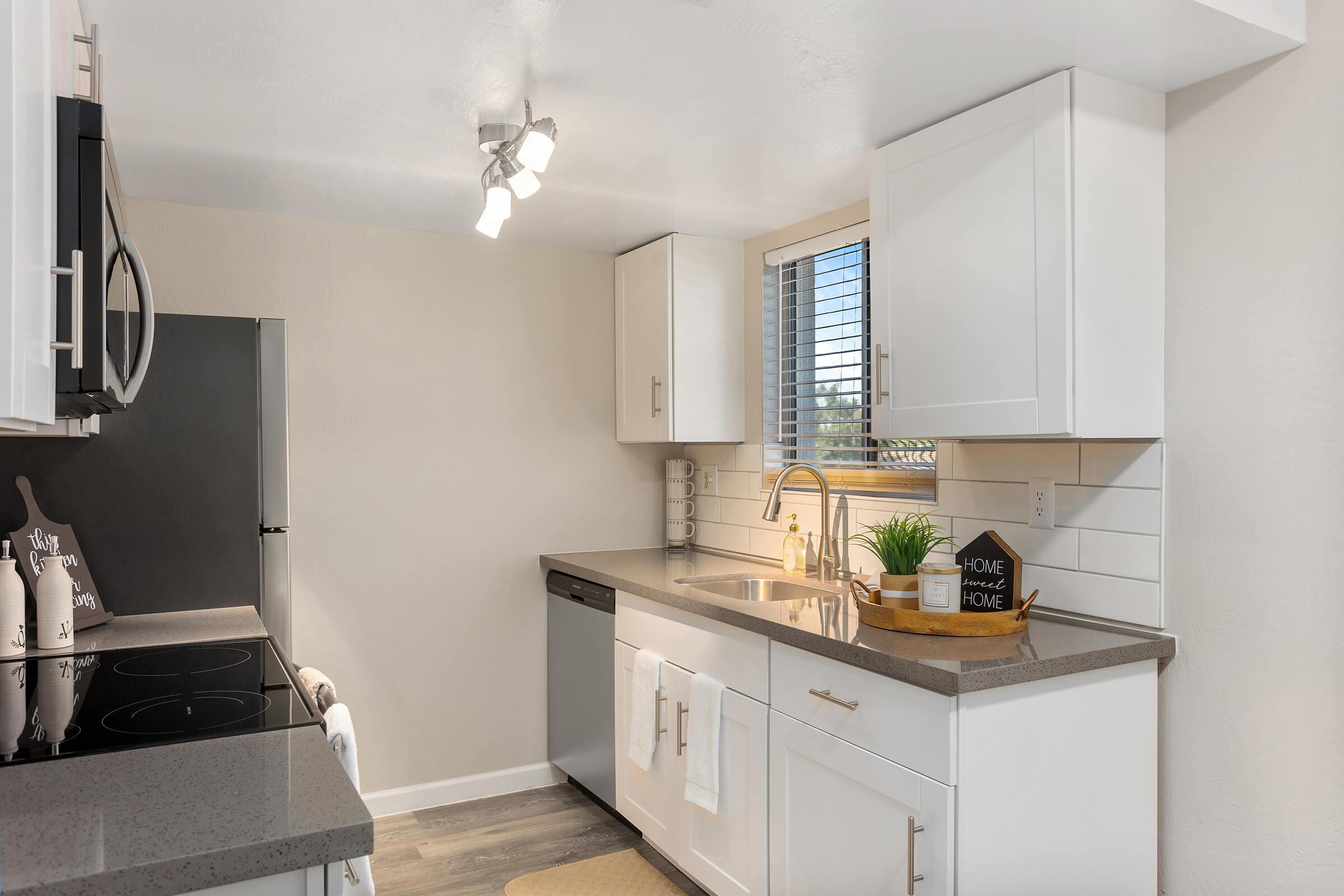 a kitchen with a sink and a mirror