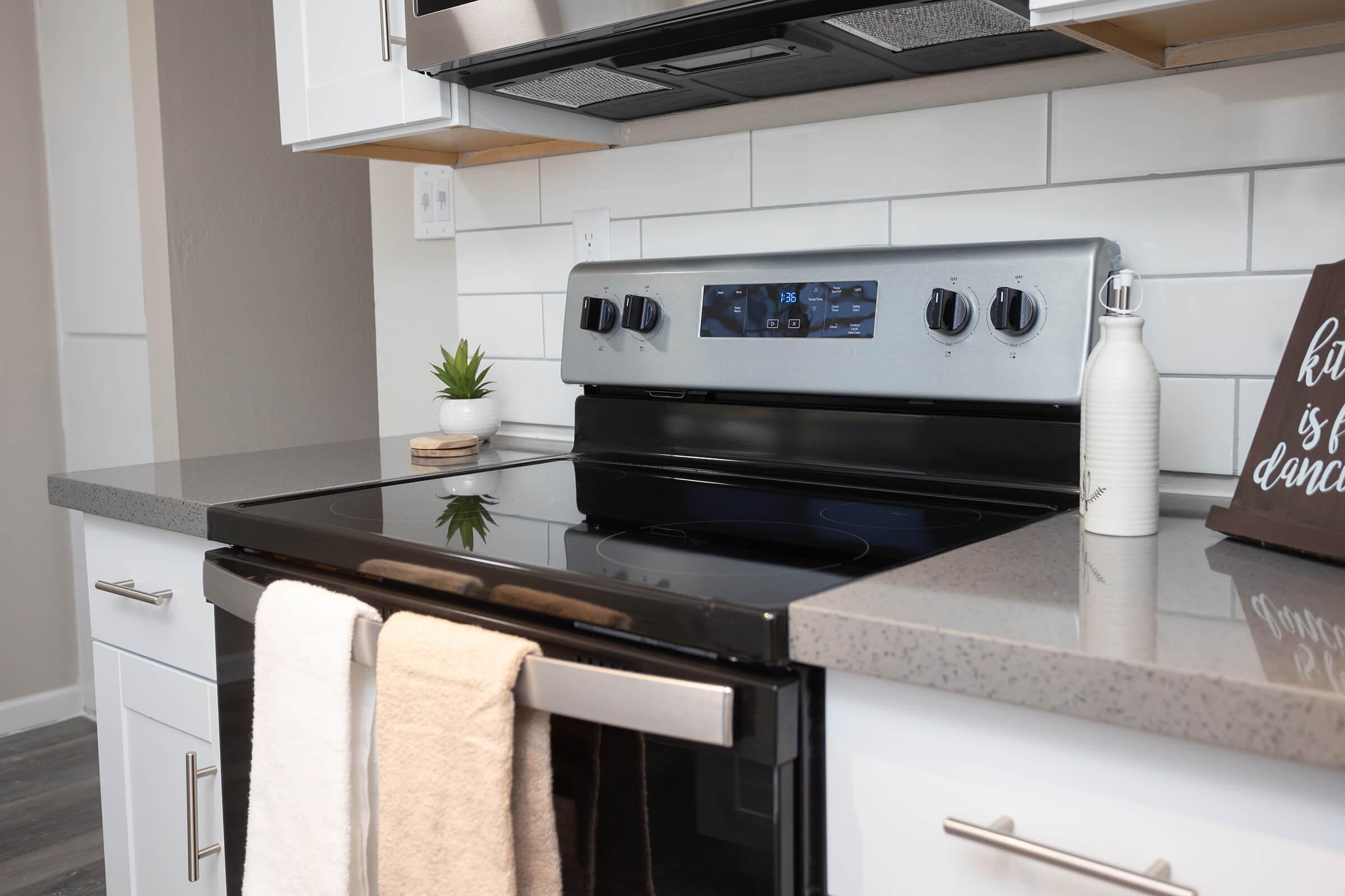 a stove top oven sitting inside of a kitchen