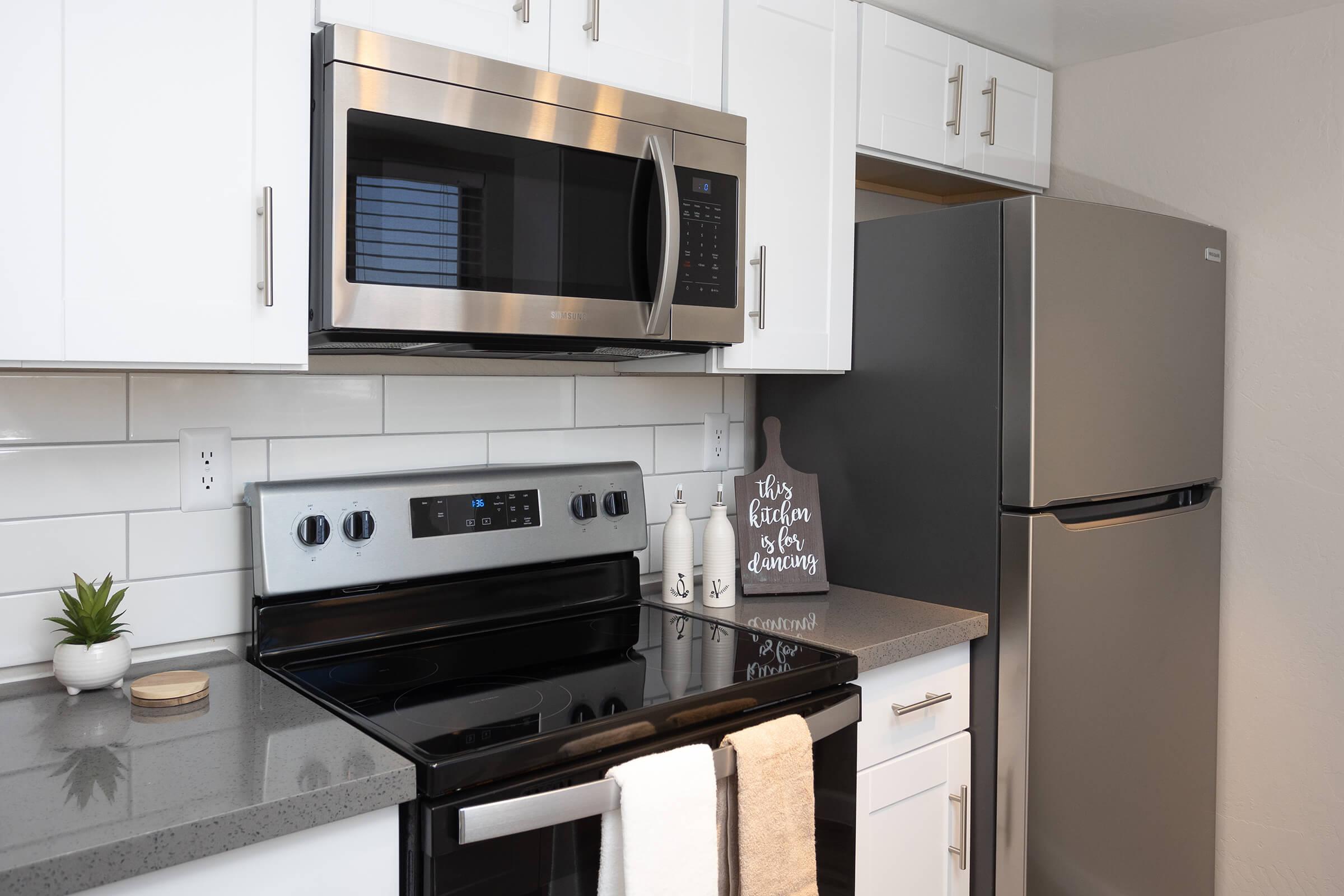STAINLESS STEEL APPLIANCES LIKE A MICROWAVE AND REFRIGERATOR