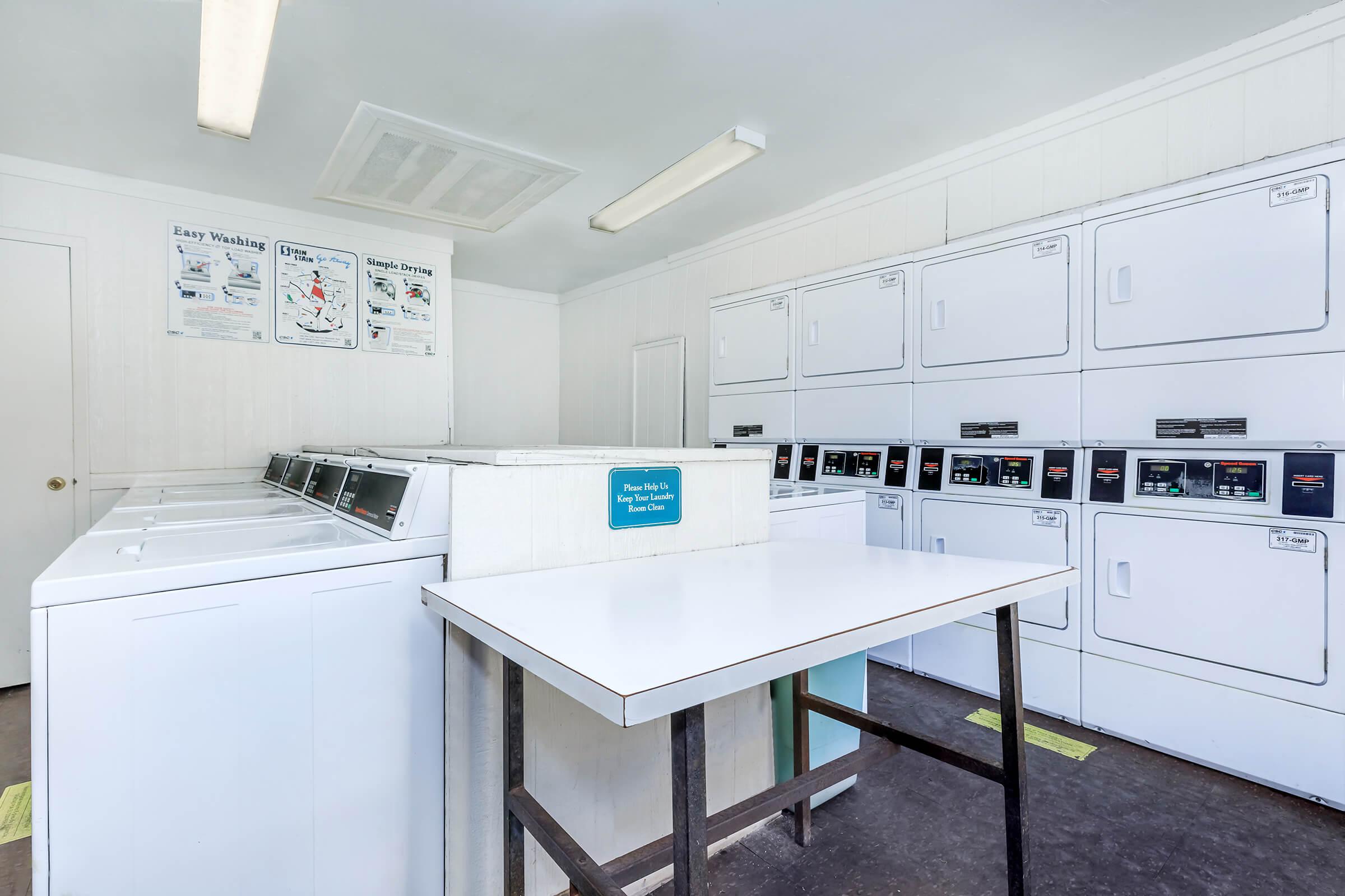 a kitchen with a refrigerator and a table