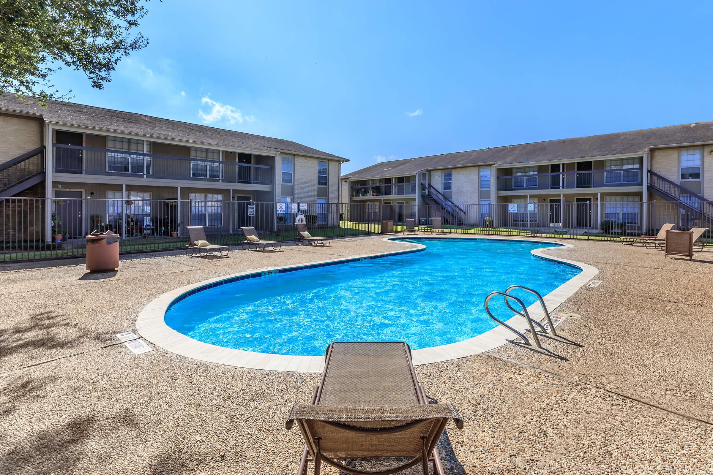 a house on a beach in front of a pool