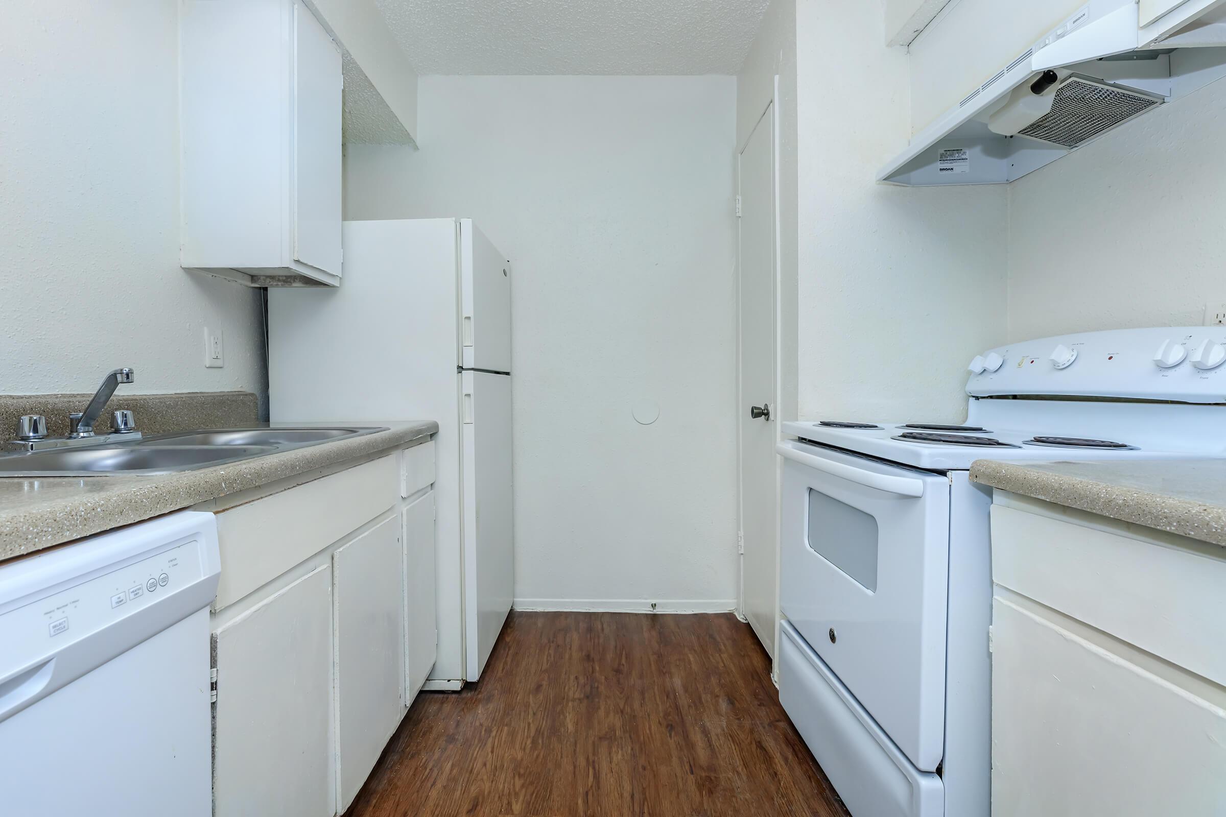 a kitchen with a stove and a refrigerator