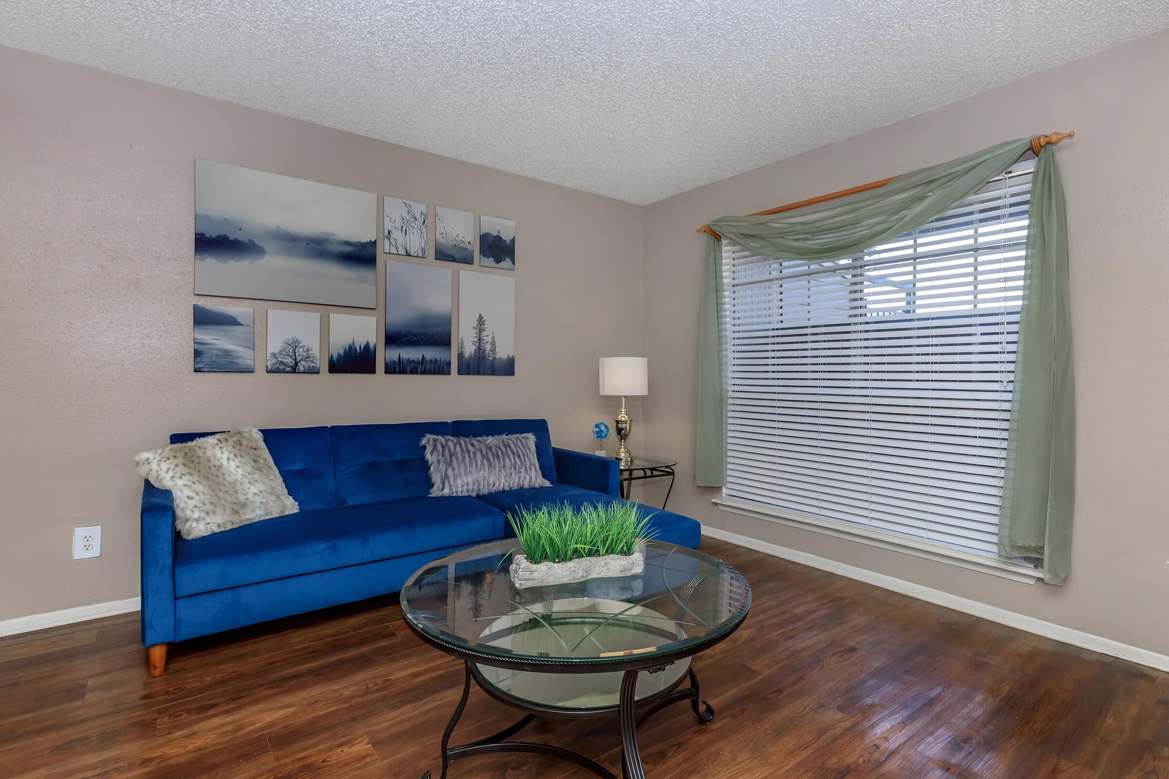 a living room filled with furniture and a large window