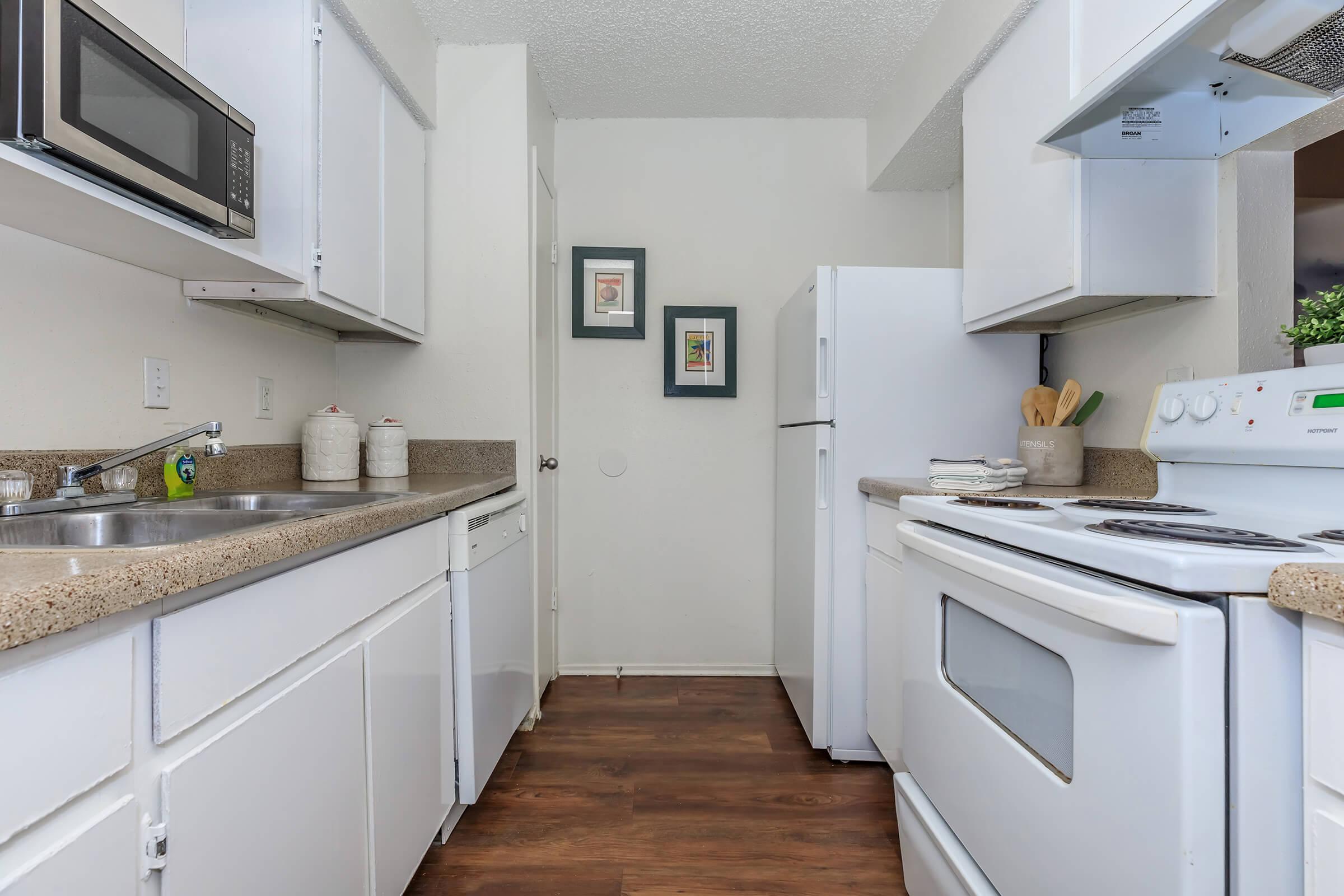 a kitchen with a stove sink and refrigerator