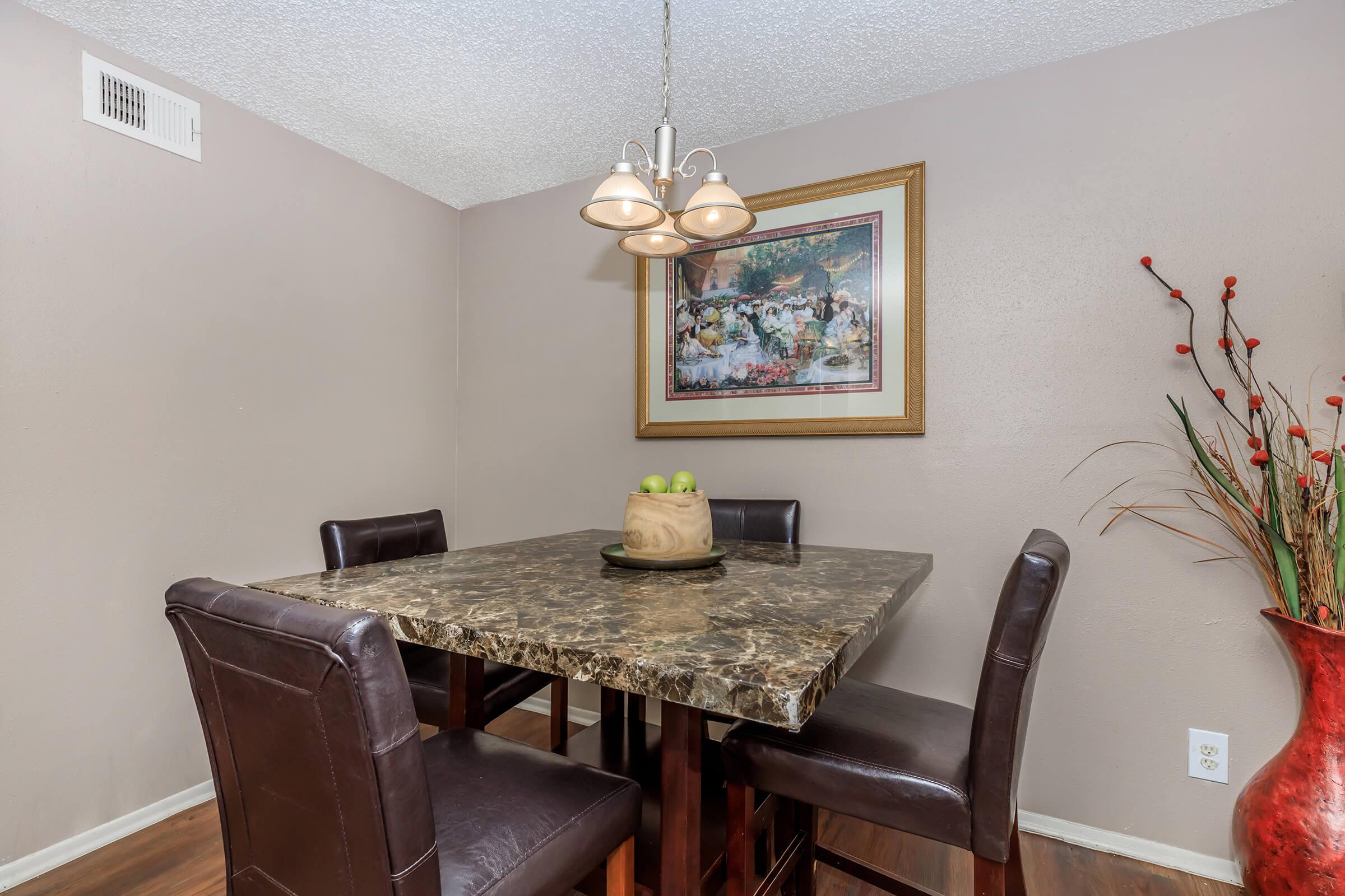 a room filled with furniture and vase of flowers on a table