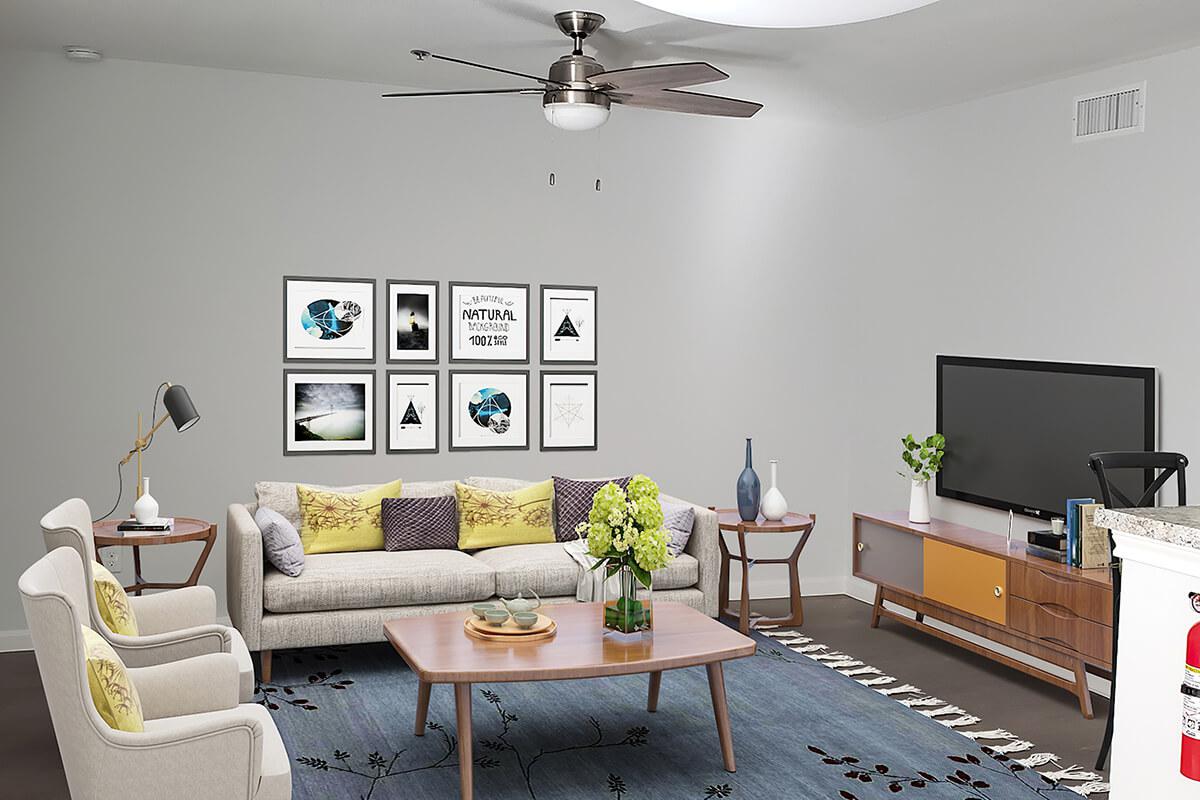 a living room filled with furniture and a flat screen tv