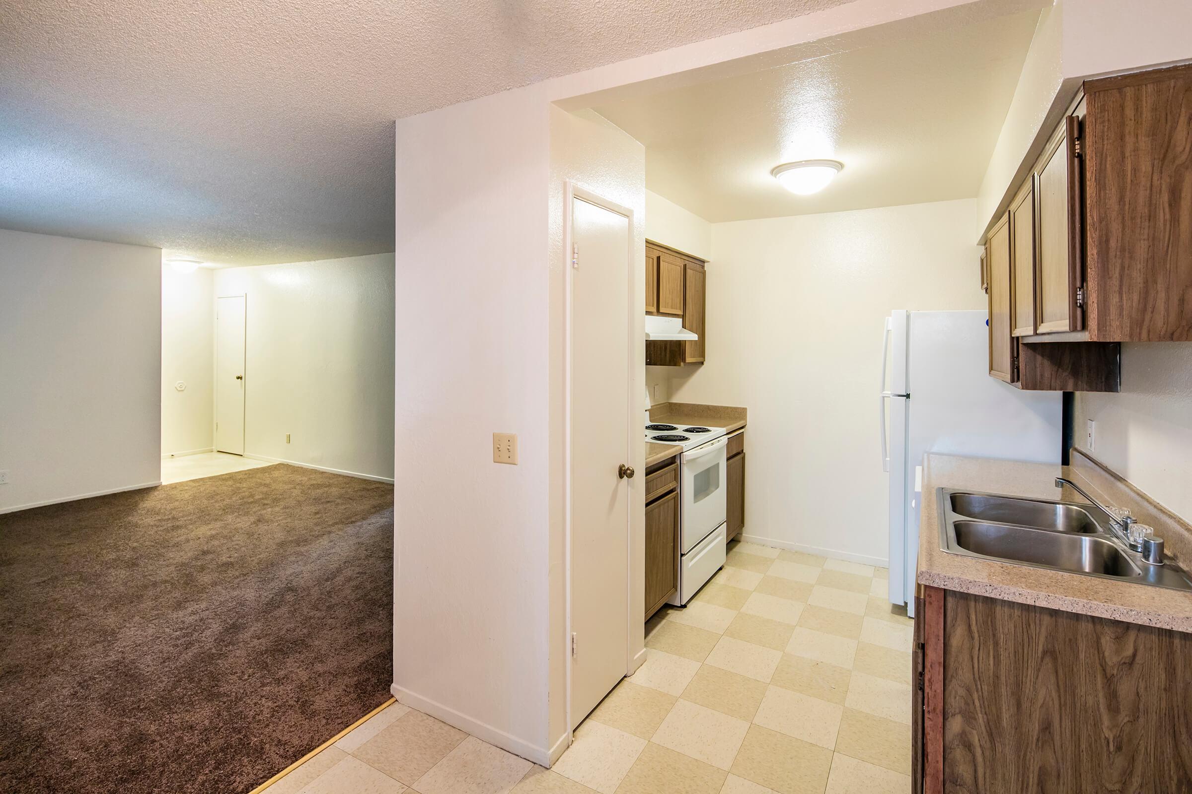 a kitchen with a sink and a refrigerator