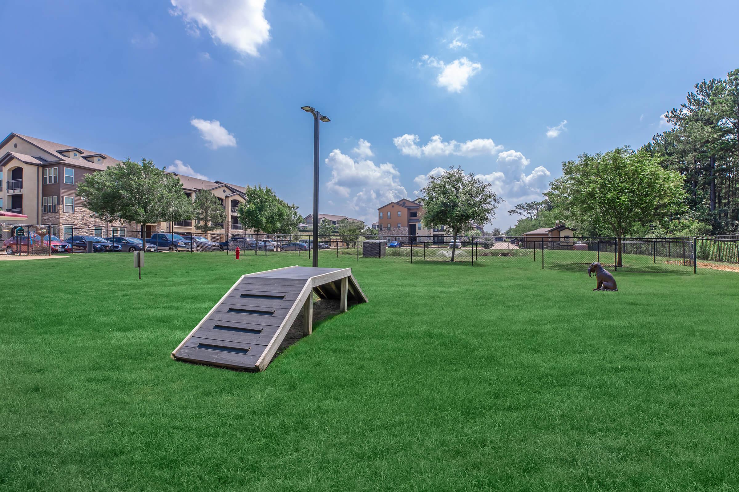 a couple of lawn chairs sitting on top of a lush green field