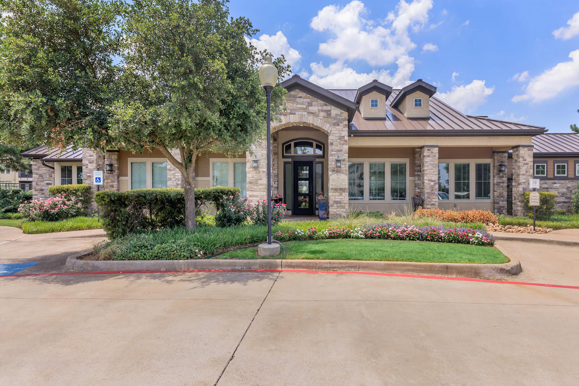 Paladin Apartments leasing office with green grass