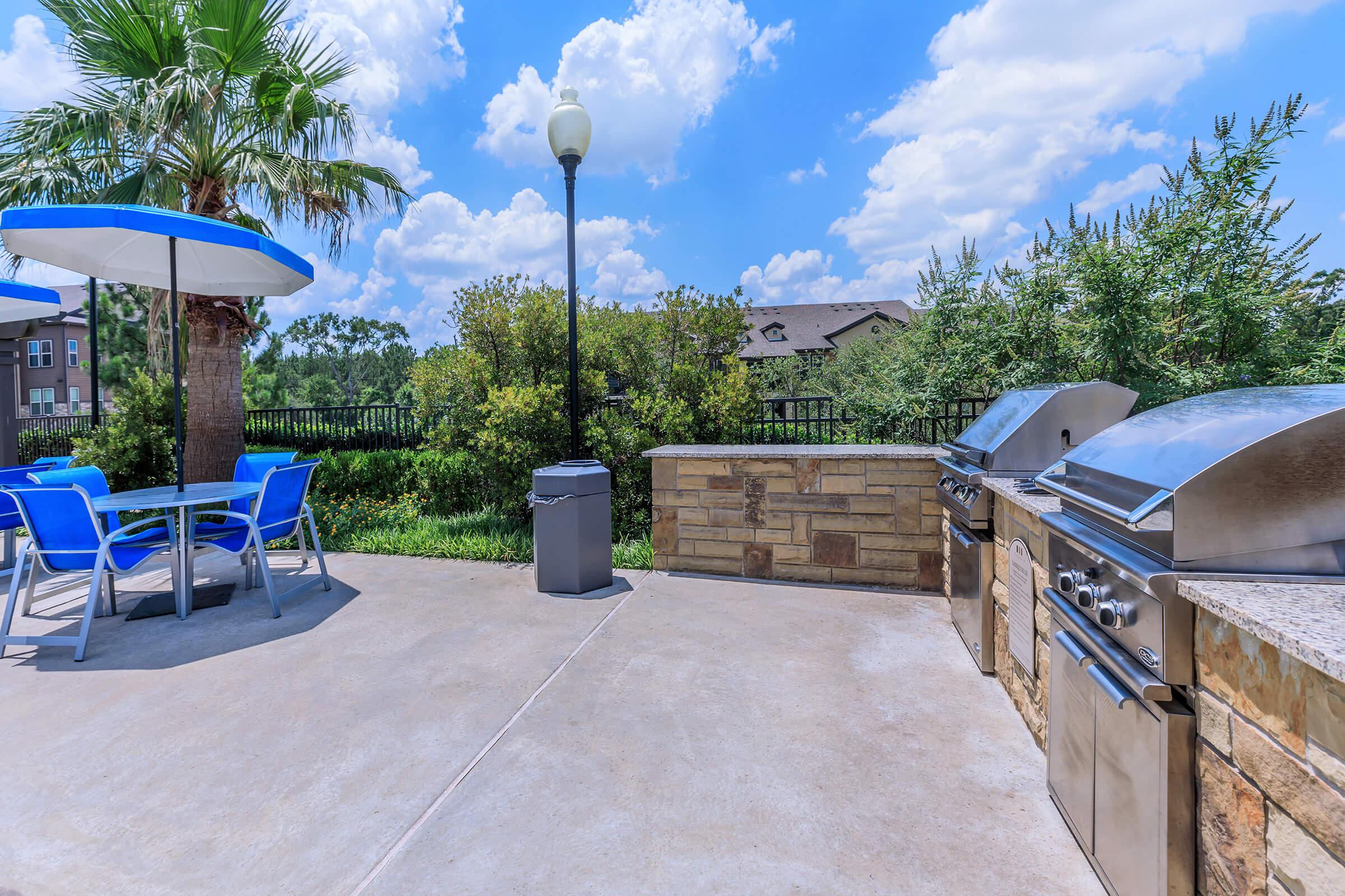 stainless steel barbecues with a table and chairs