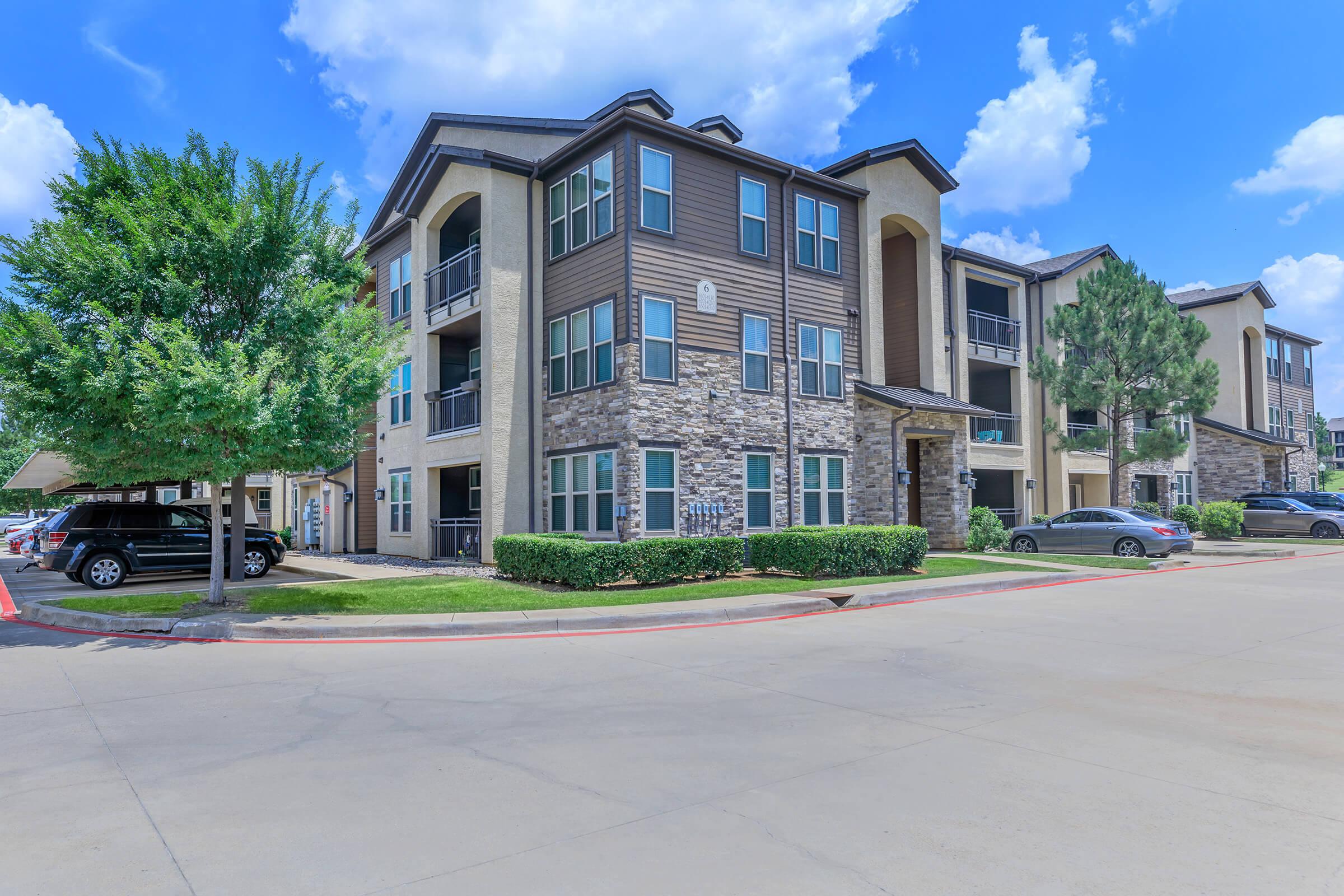 Paladin Apartments community building with green shrubs