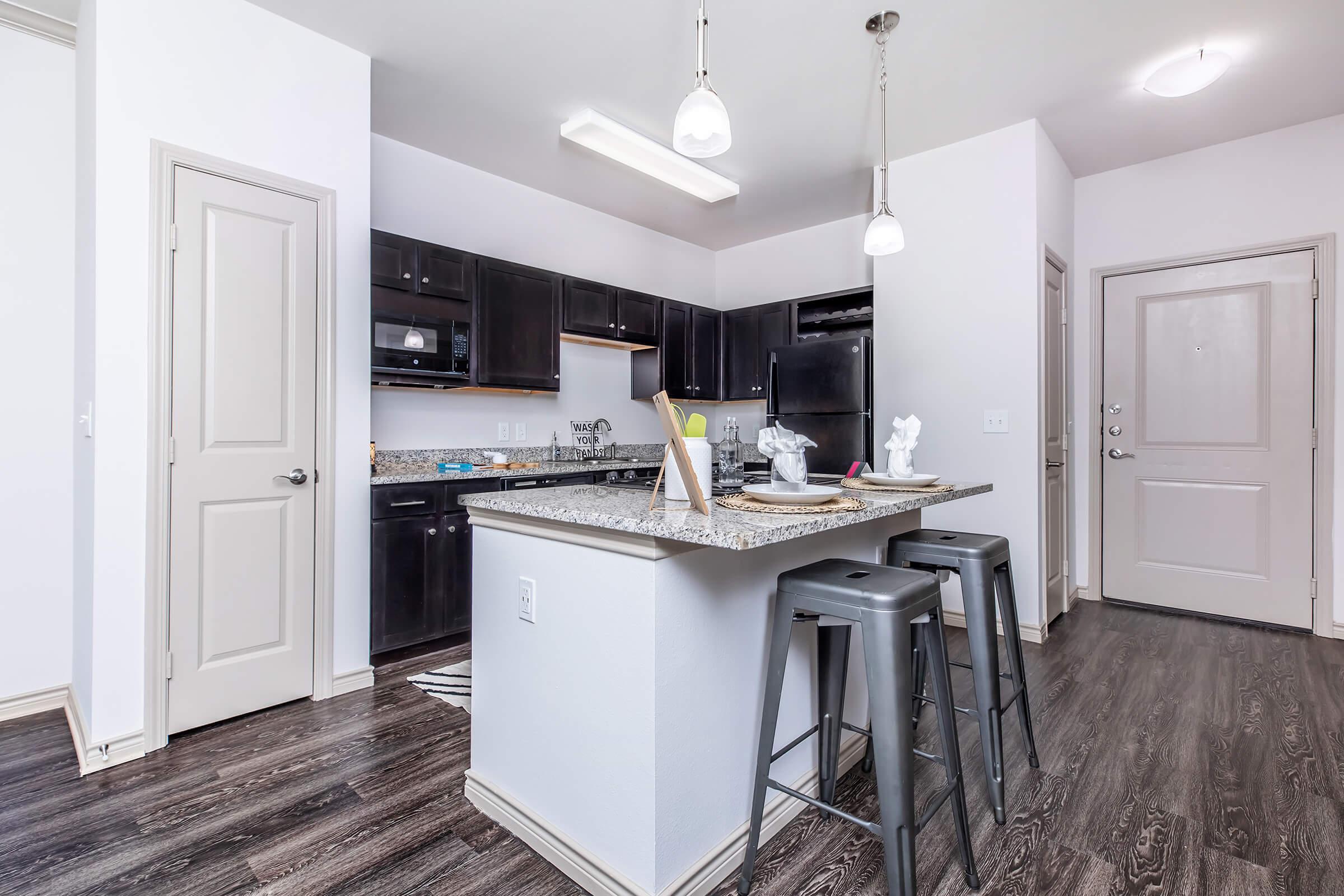 a kitchen with a sink and a refrigerator