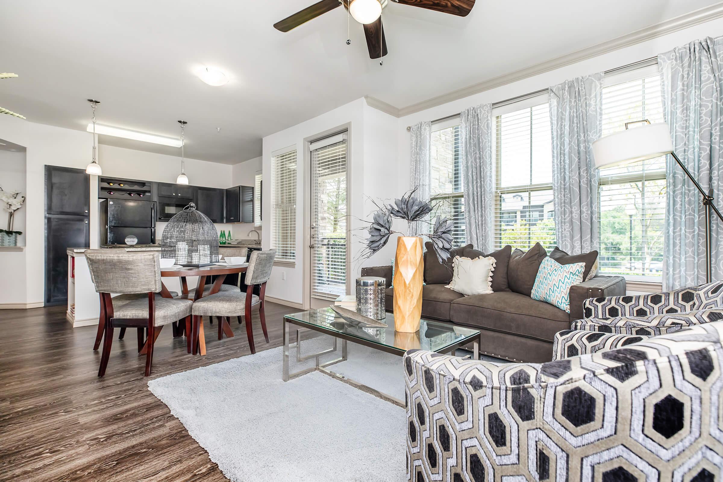 a living room filled with furniture and a large window