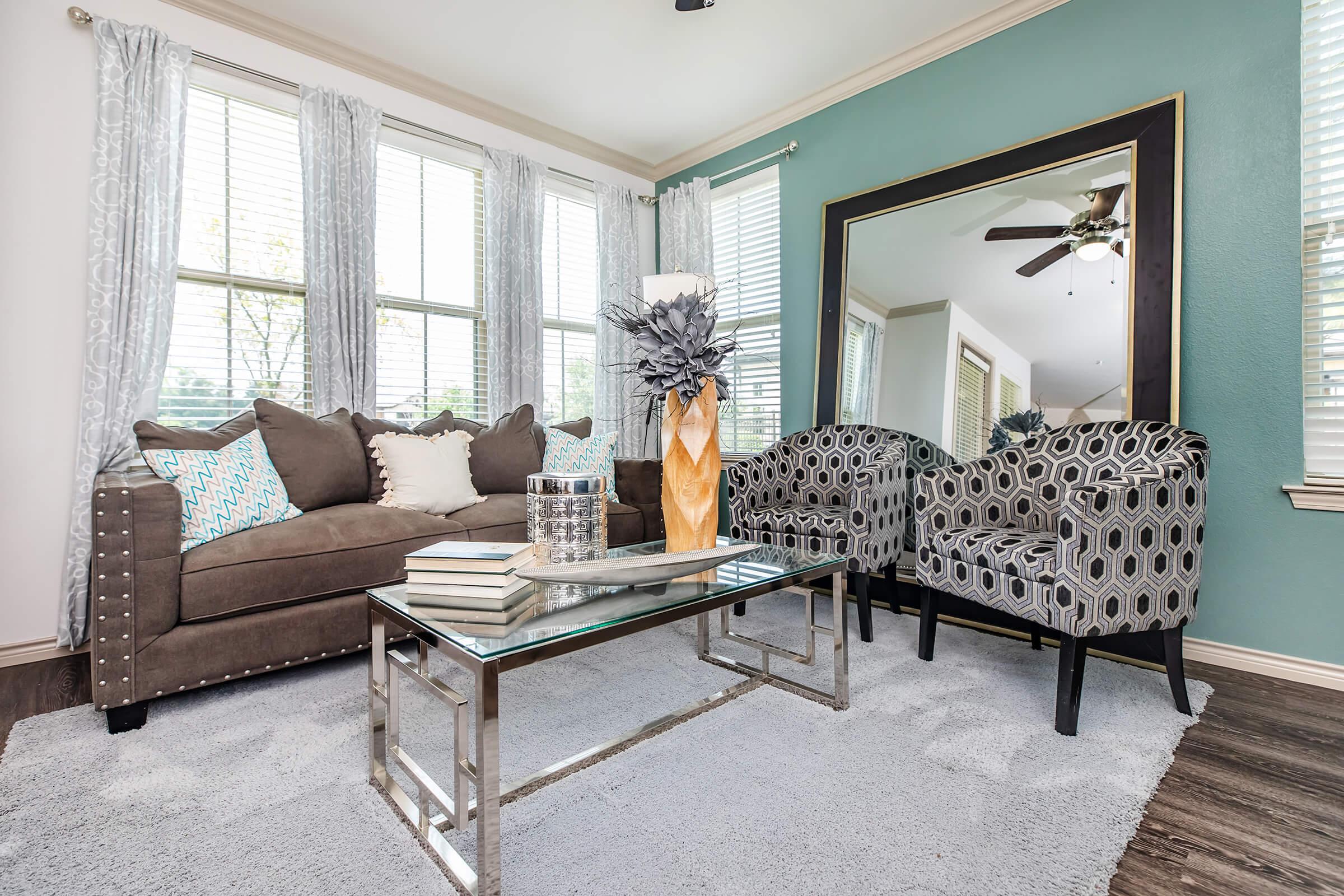 a living room filled with furniture and a large window