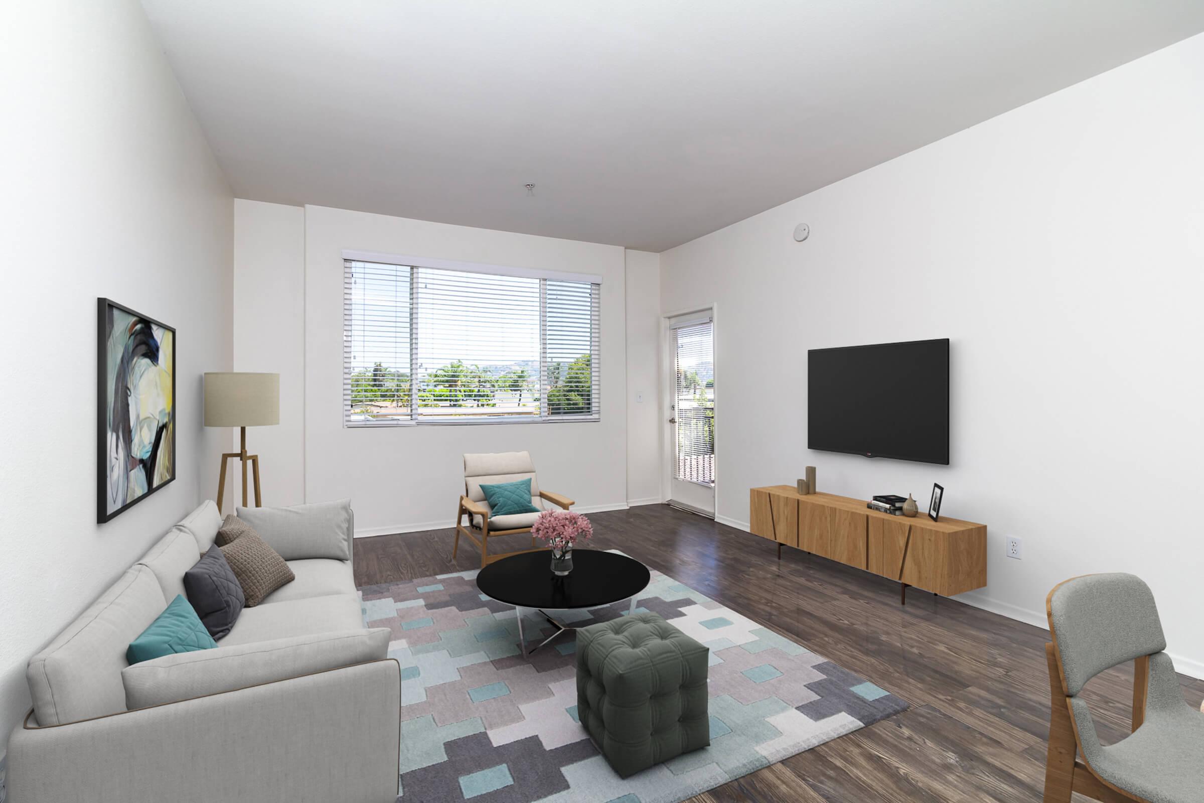 a living room filled with furniture and a flat screen tv