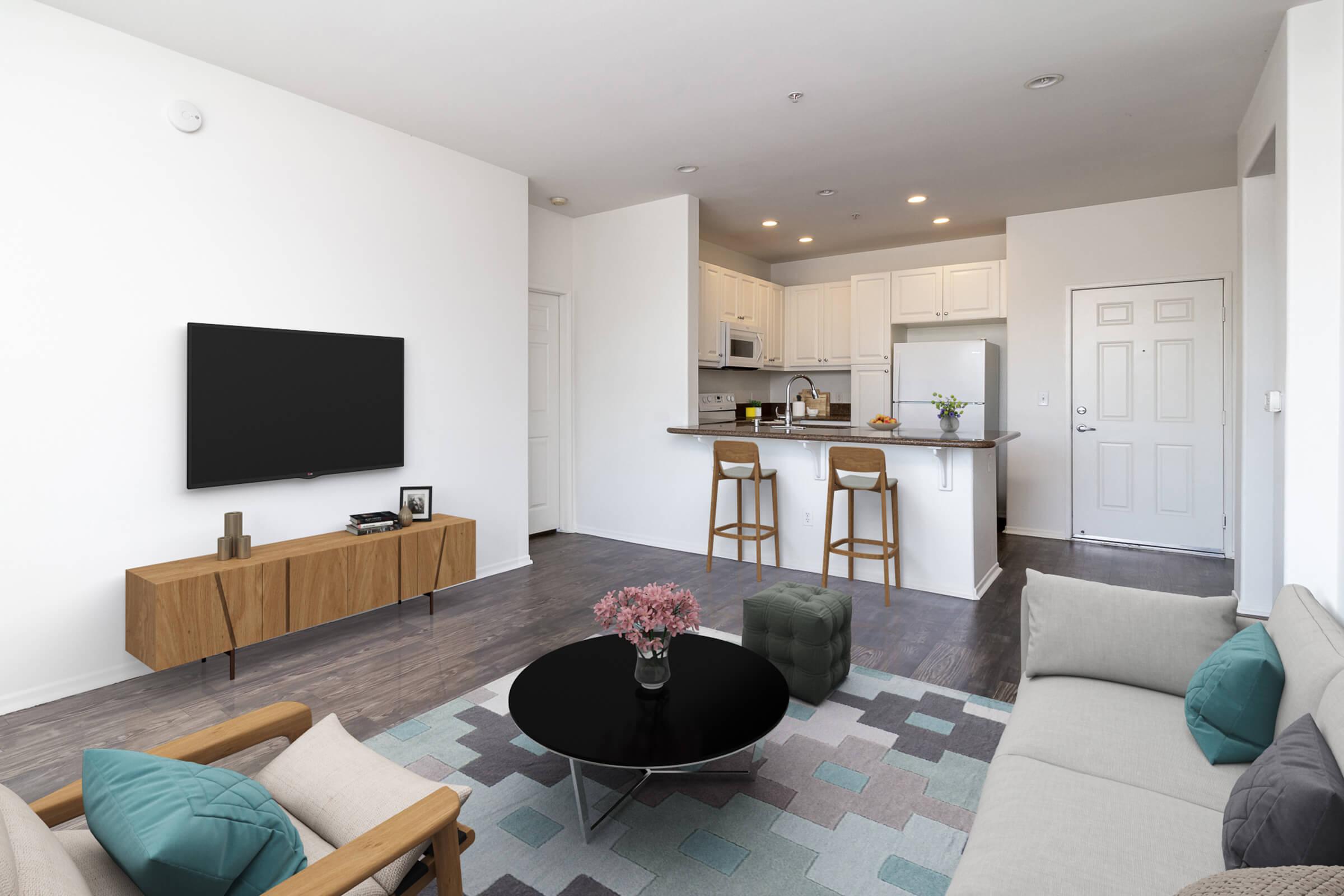 a living room filled with furniture and a flat screen tv
