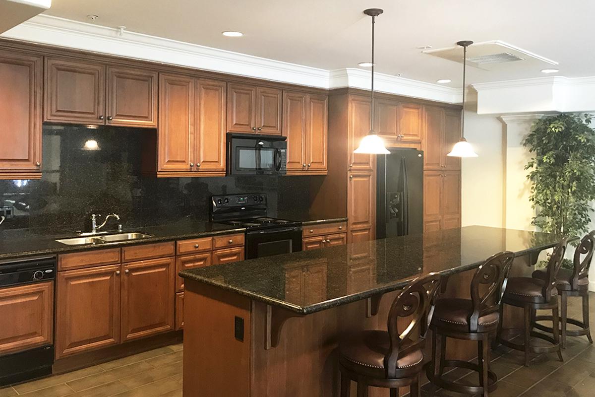 a modern kitchen with stainless steel appliances and wooden cabinets