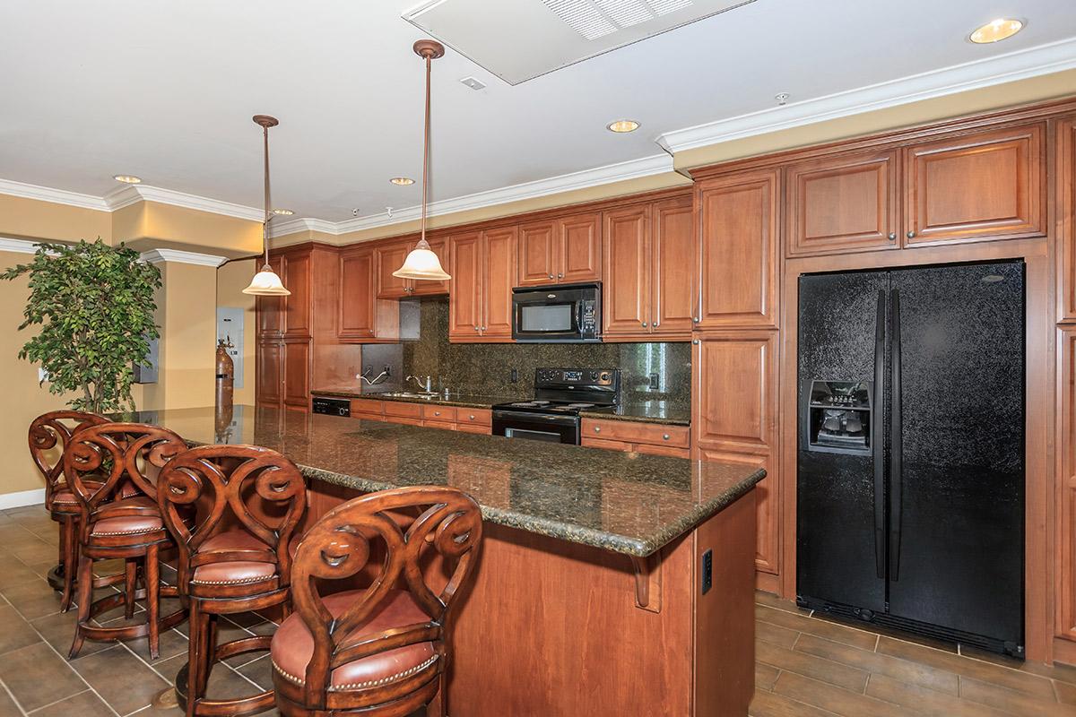 a kitchen with wooden cabinets and a dining room table