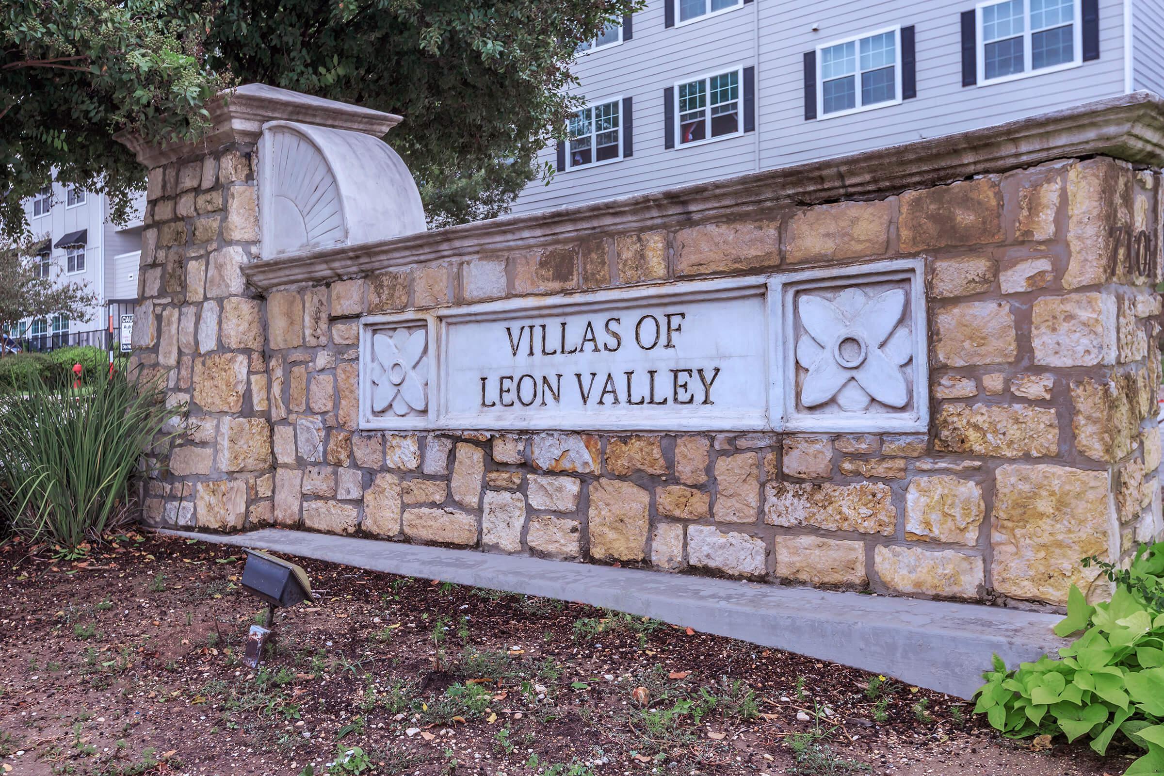 a sign in front of a brick building