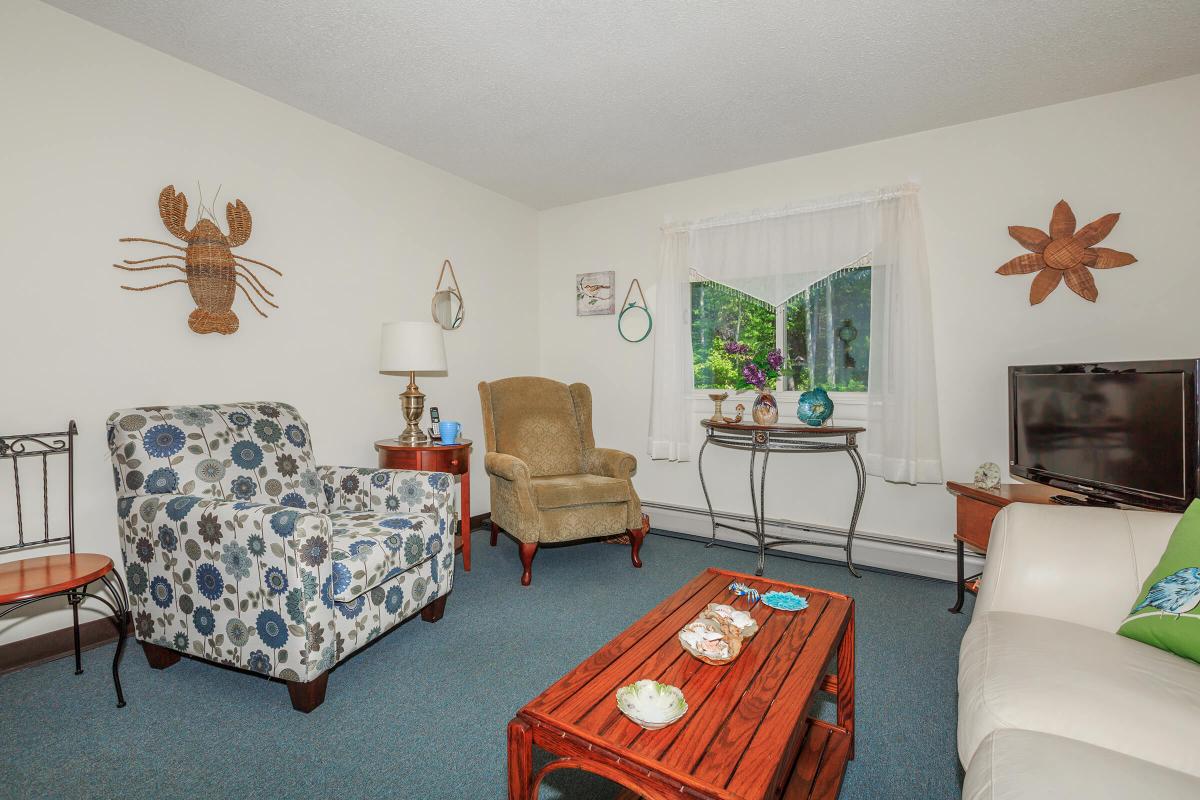 a living room filled with furniture and a bed in a bedroom