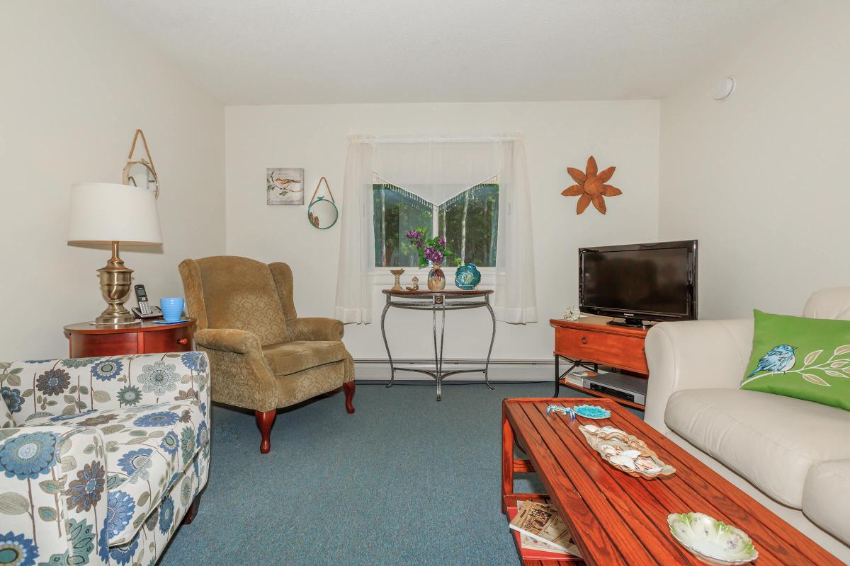 a living room filled with furniture and a flat screen tv