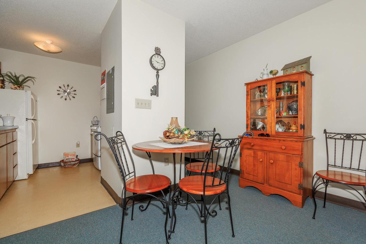 a living room filled with furniture and a red chair