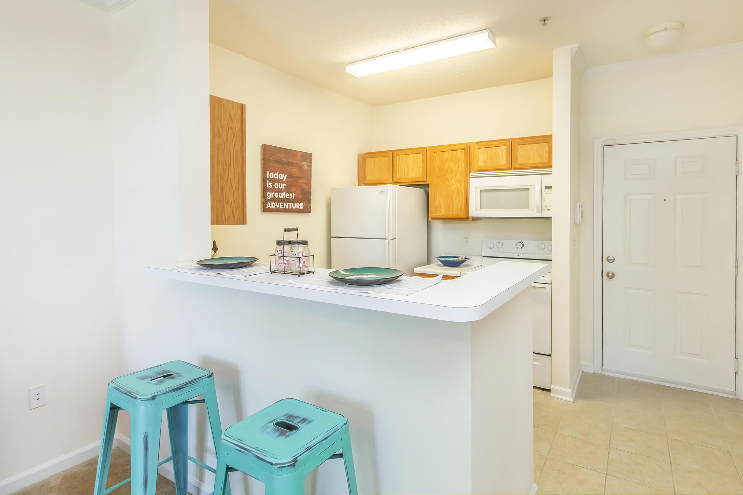 a white refrigerator freezer sitting inside of a kitchen