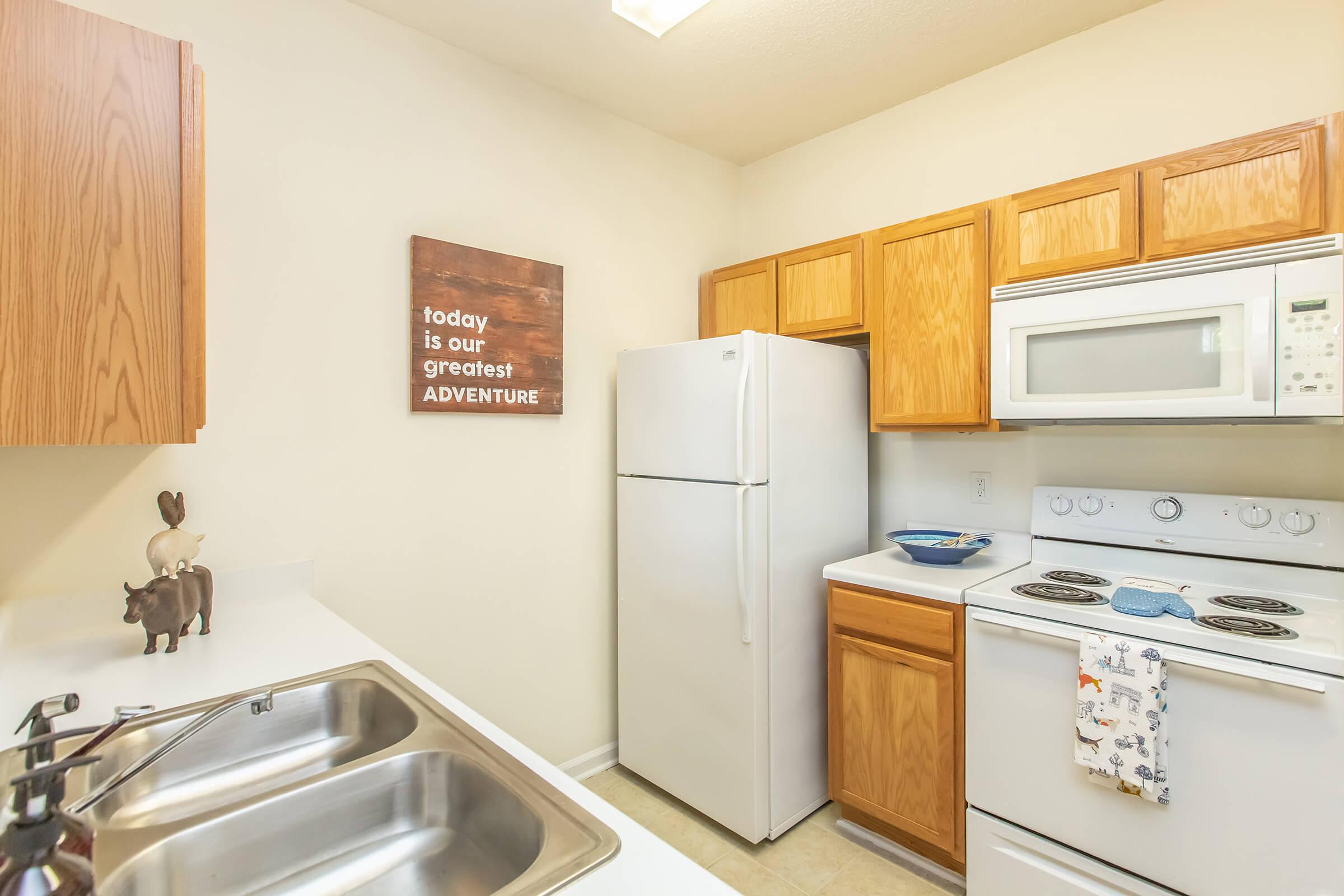 a kitchen with a stove sink and refrigerator