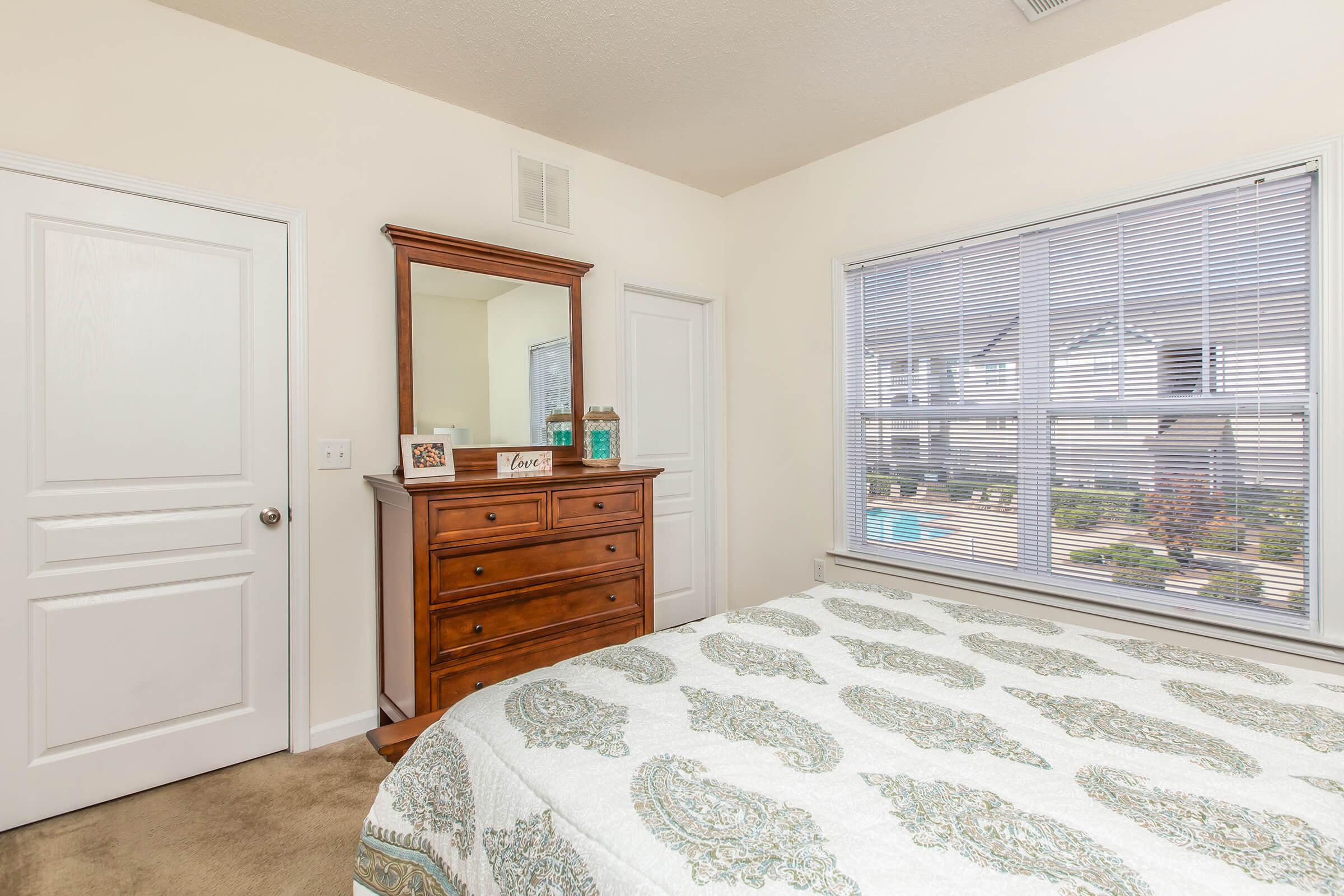 a bedroom with a bed in a room
