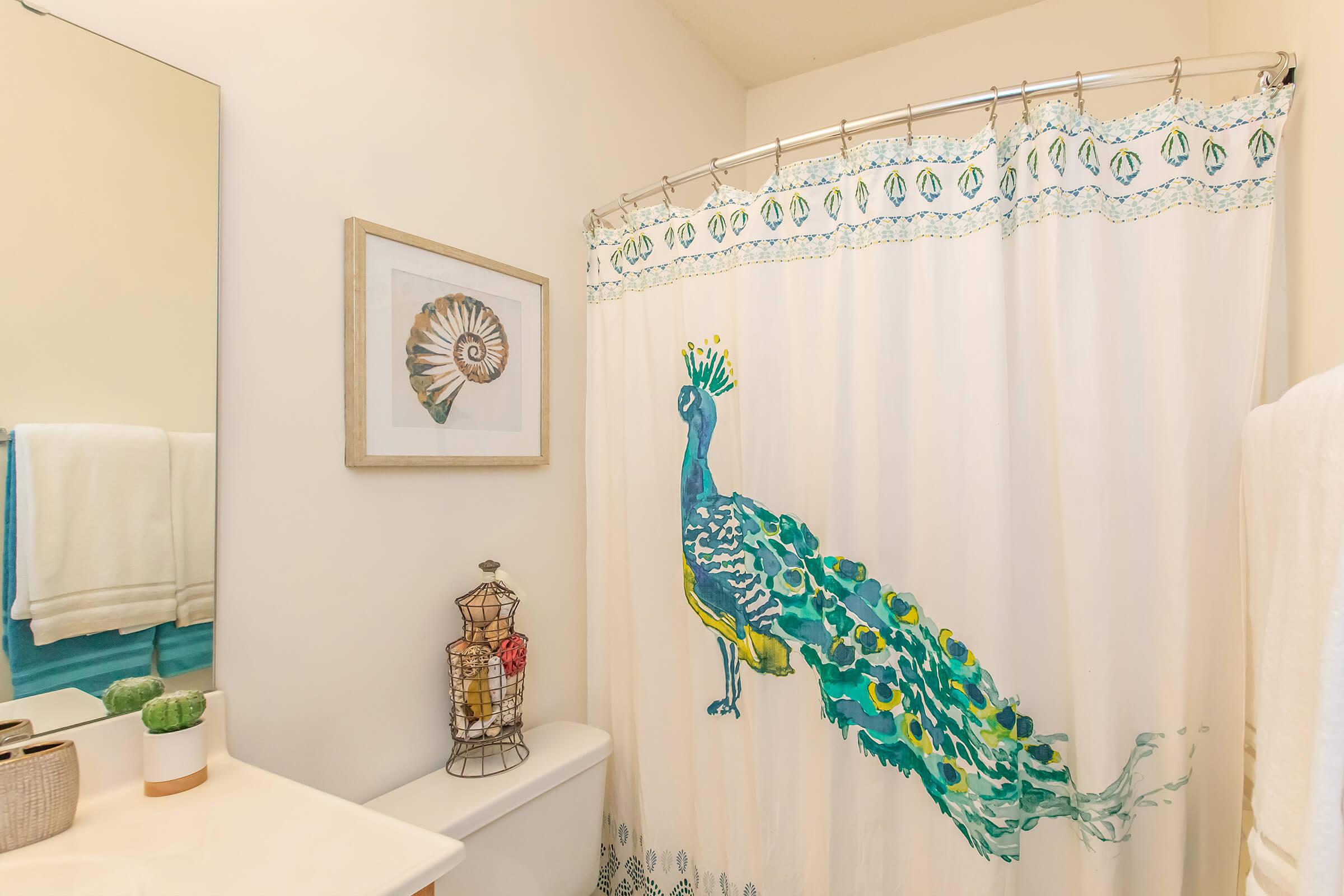 a shower curtain is decorated with white curtains