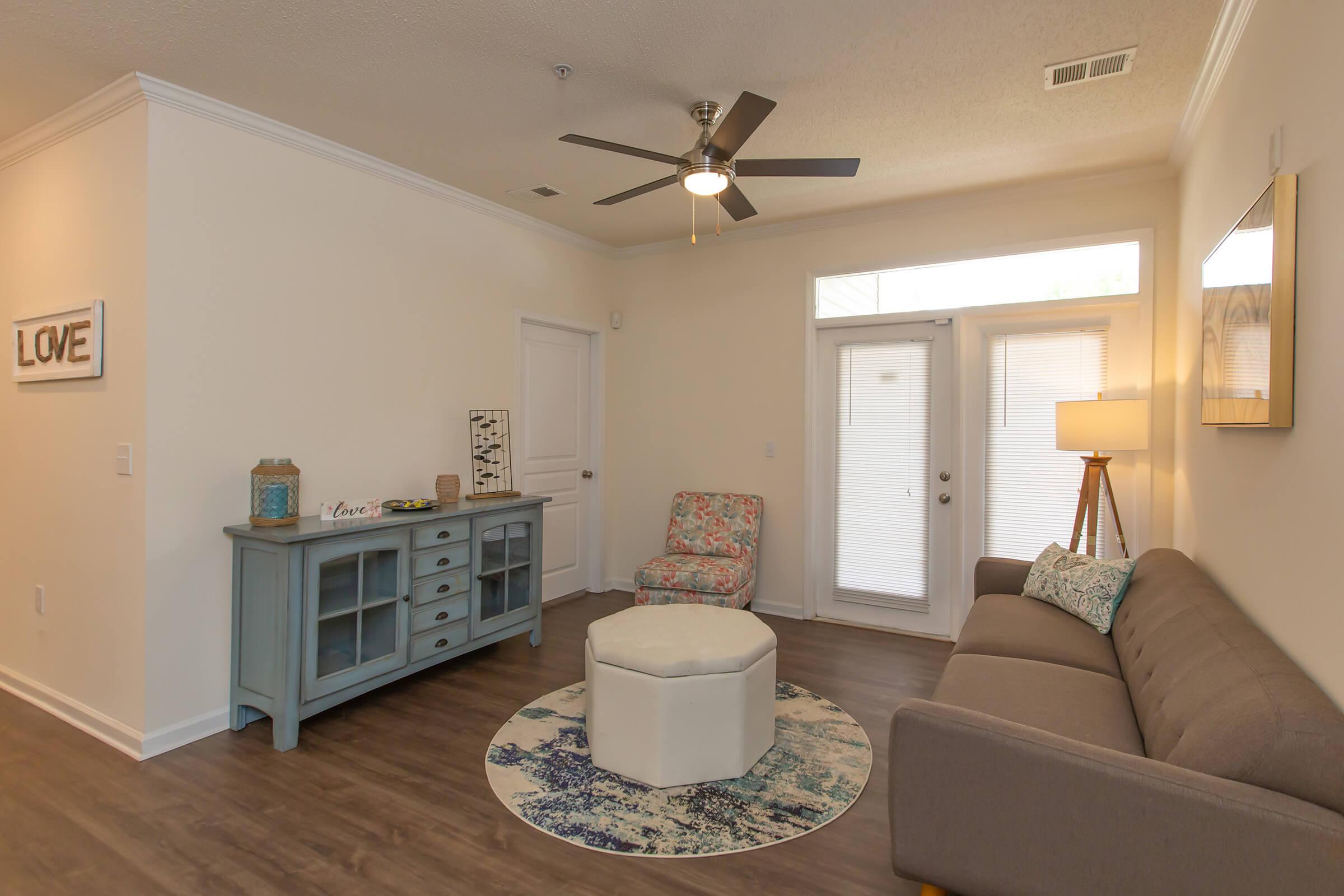 a living room filled with furniture and a flat screen tv