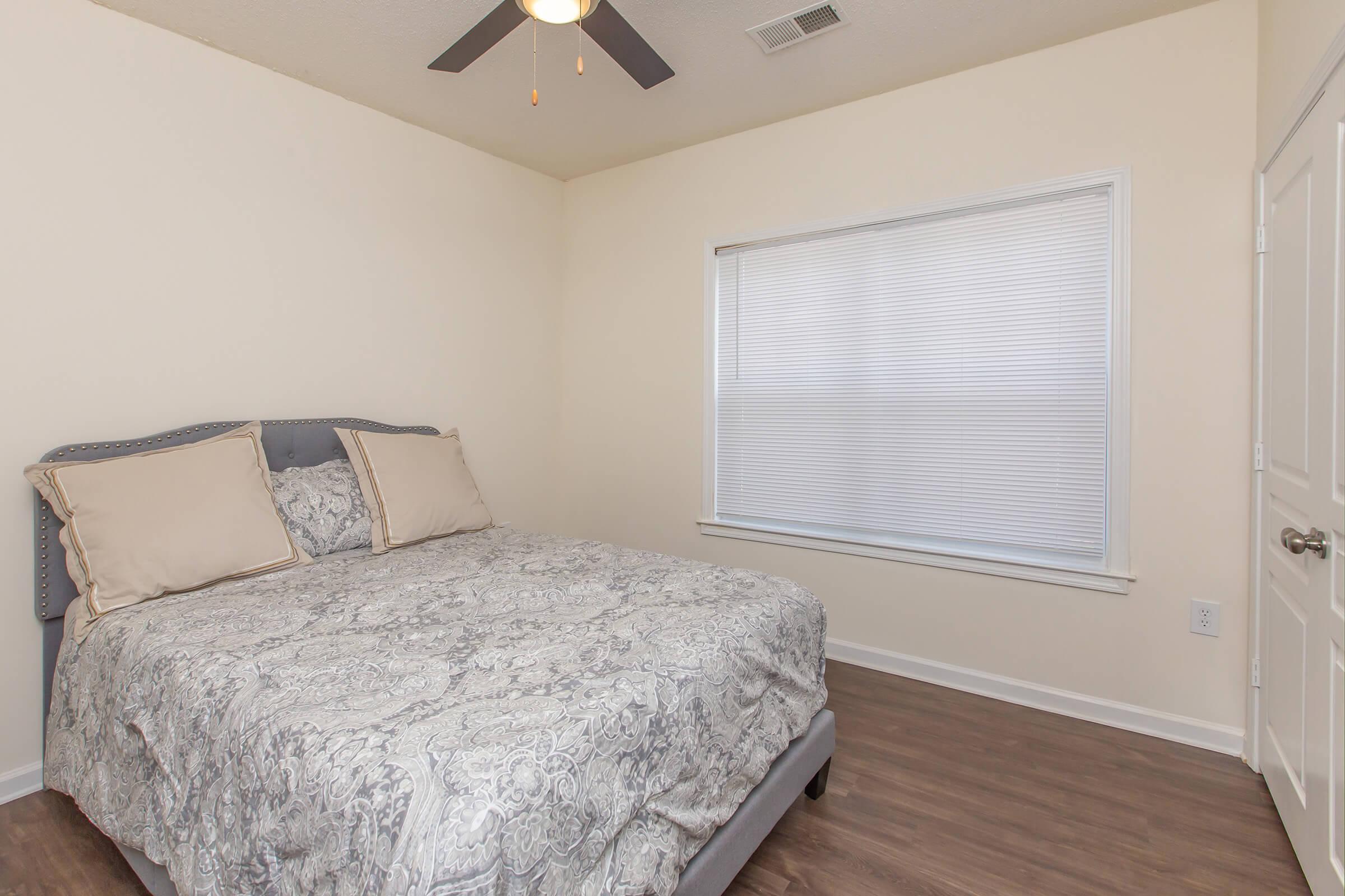 a bedroom with a bed in a room