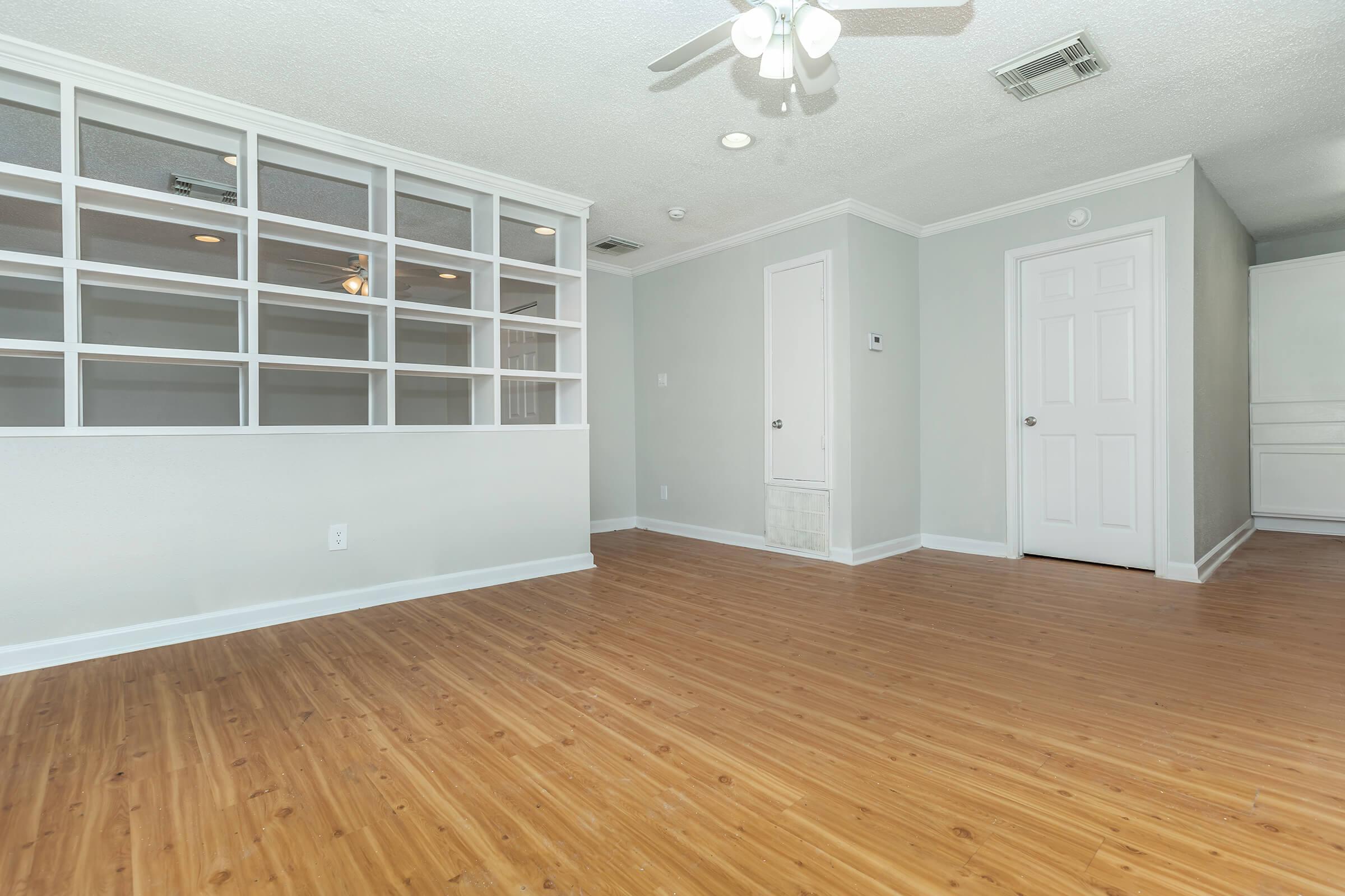 a large empty room with a wood floor