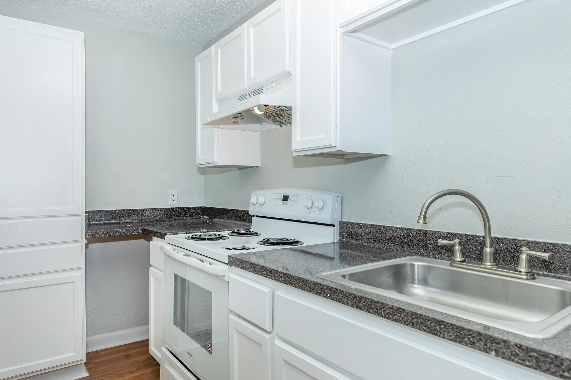 a kitchen with a stove and a sink