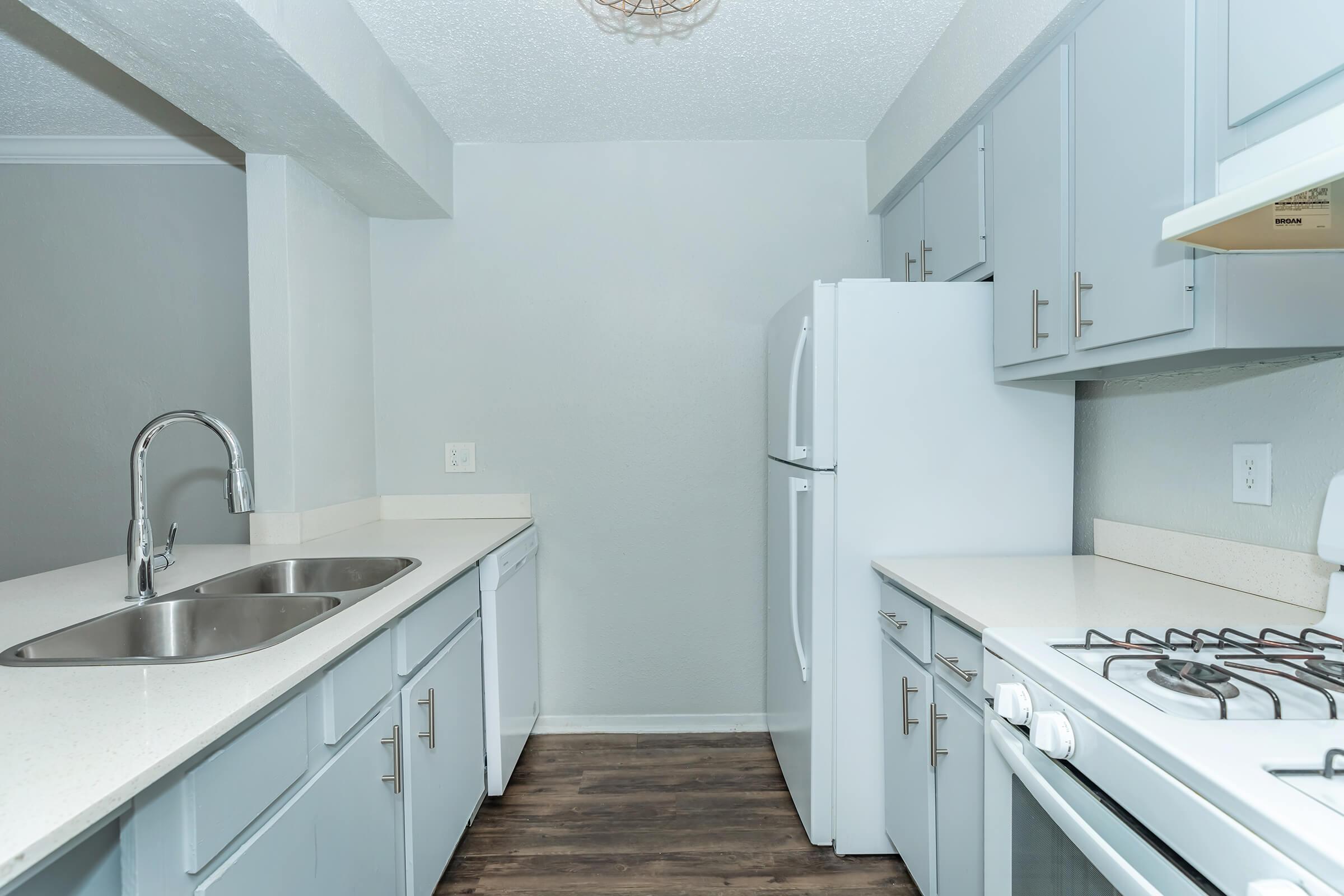 a kitchen with a sink and a mirror