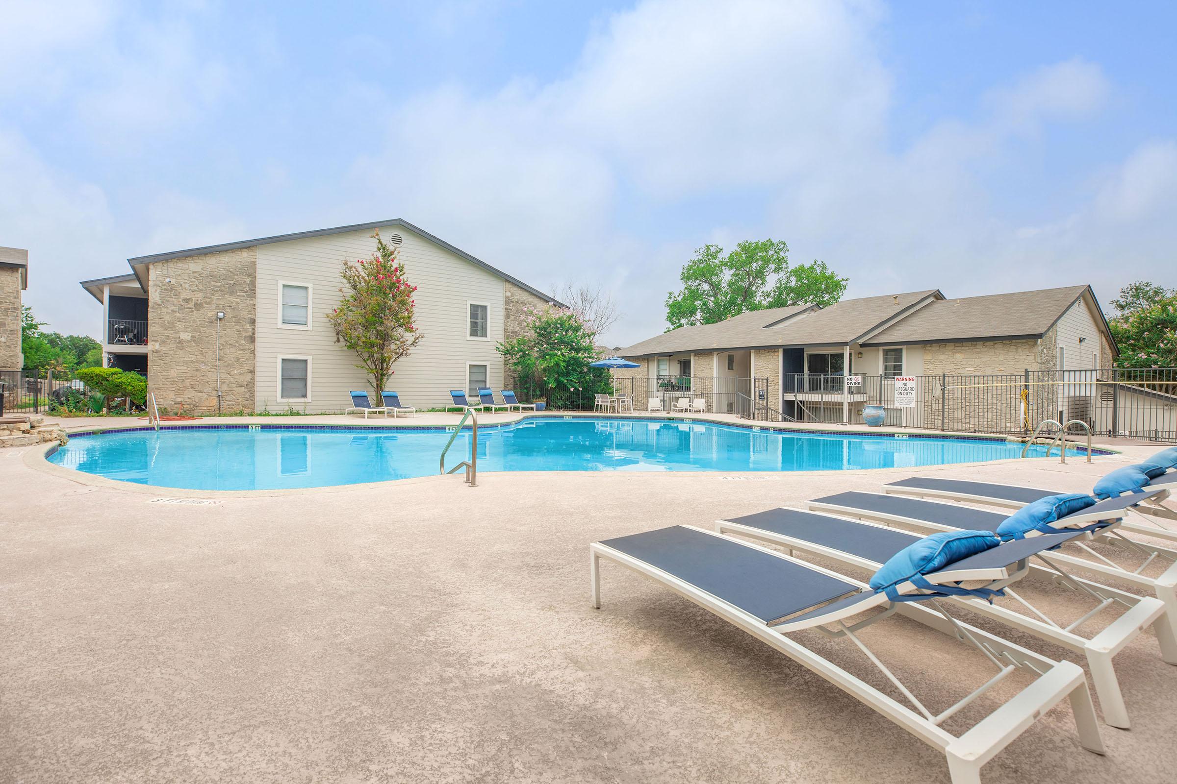 a house with a pool in front of a building