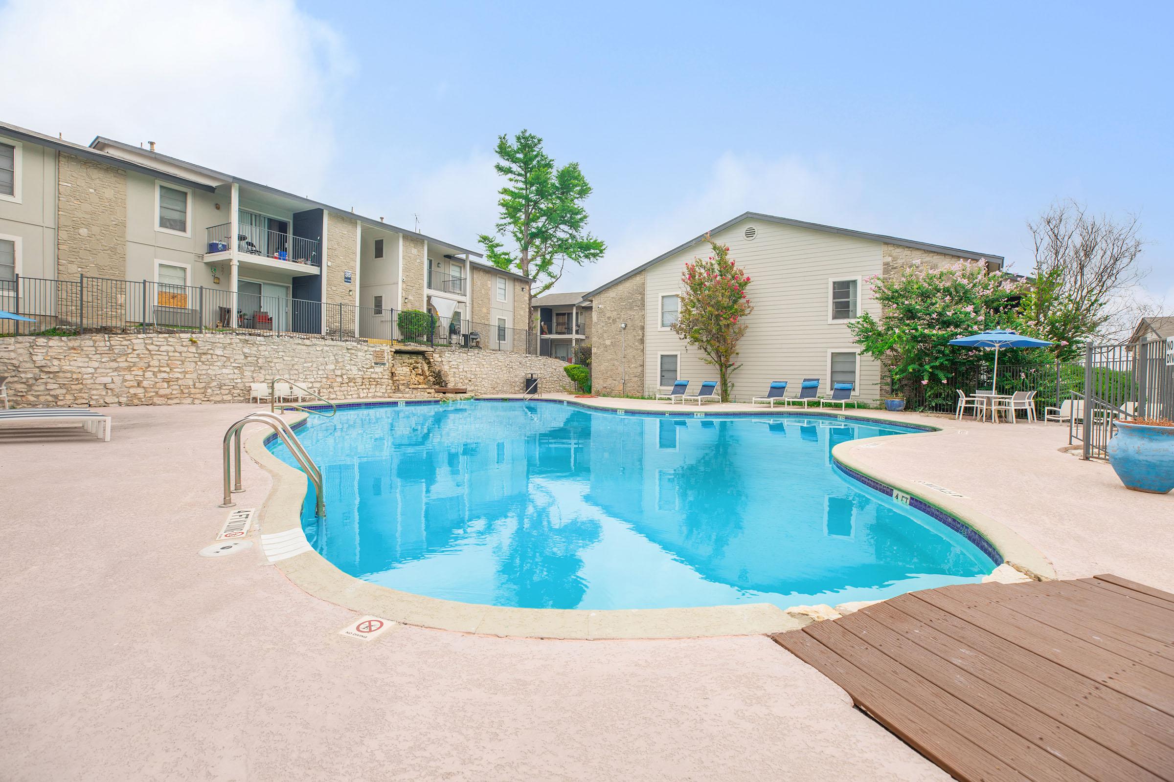 a house with a pool in front of a building