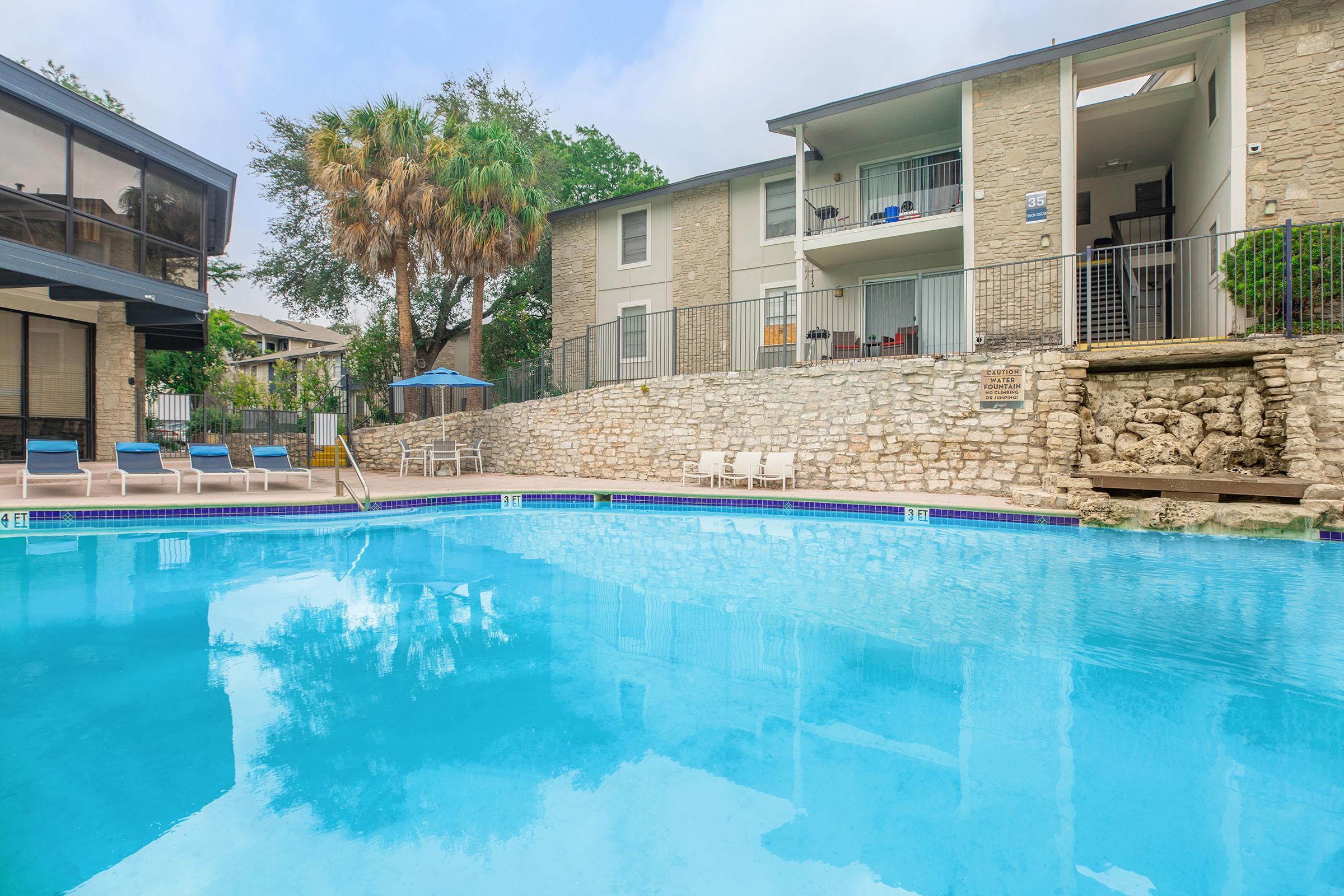 a large pool of water in front of a house