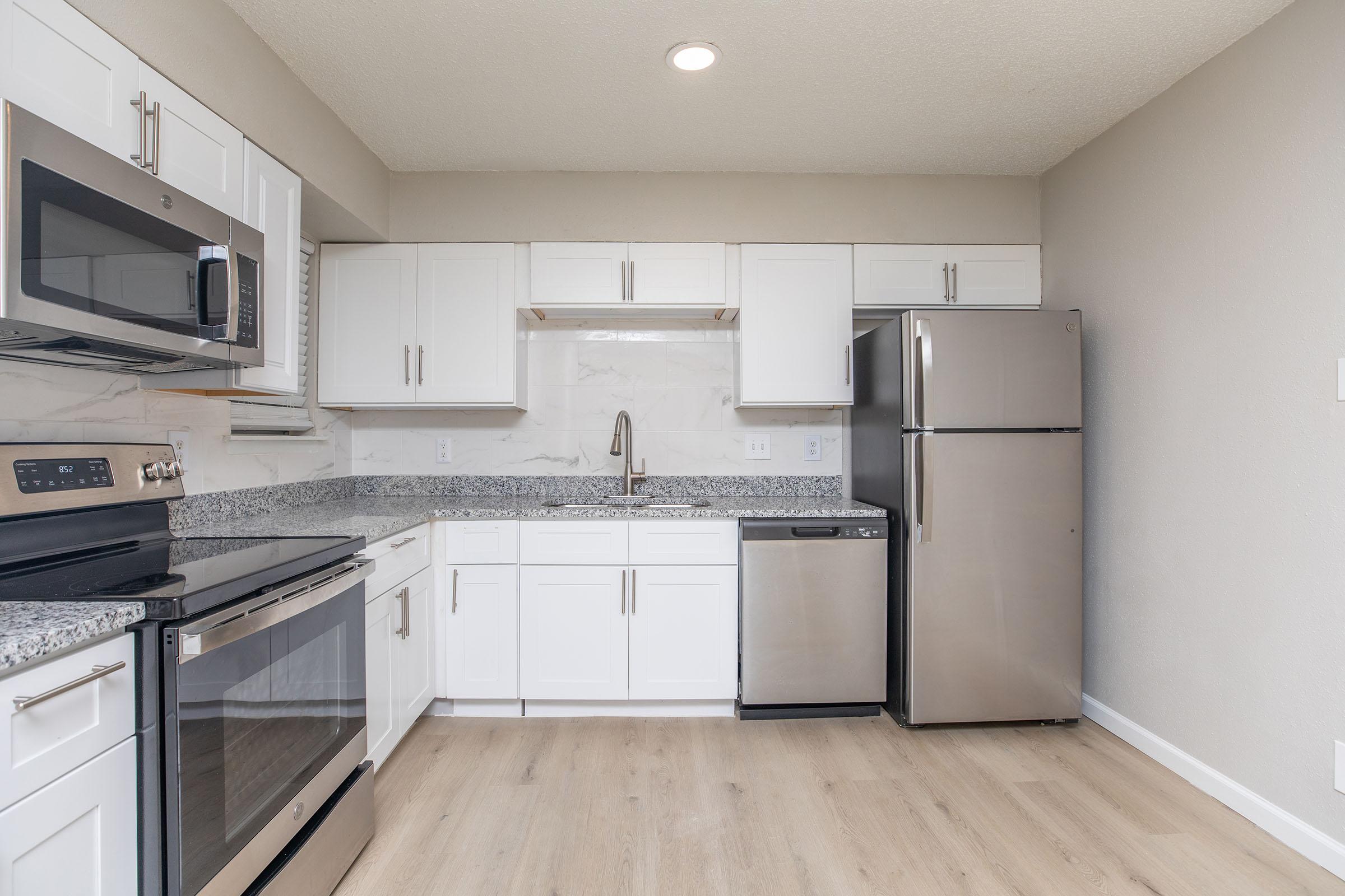 a kitchen with a stove and a refrigerator