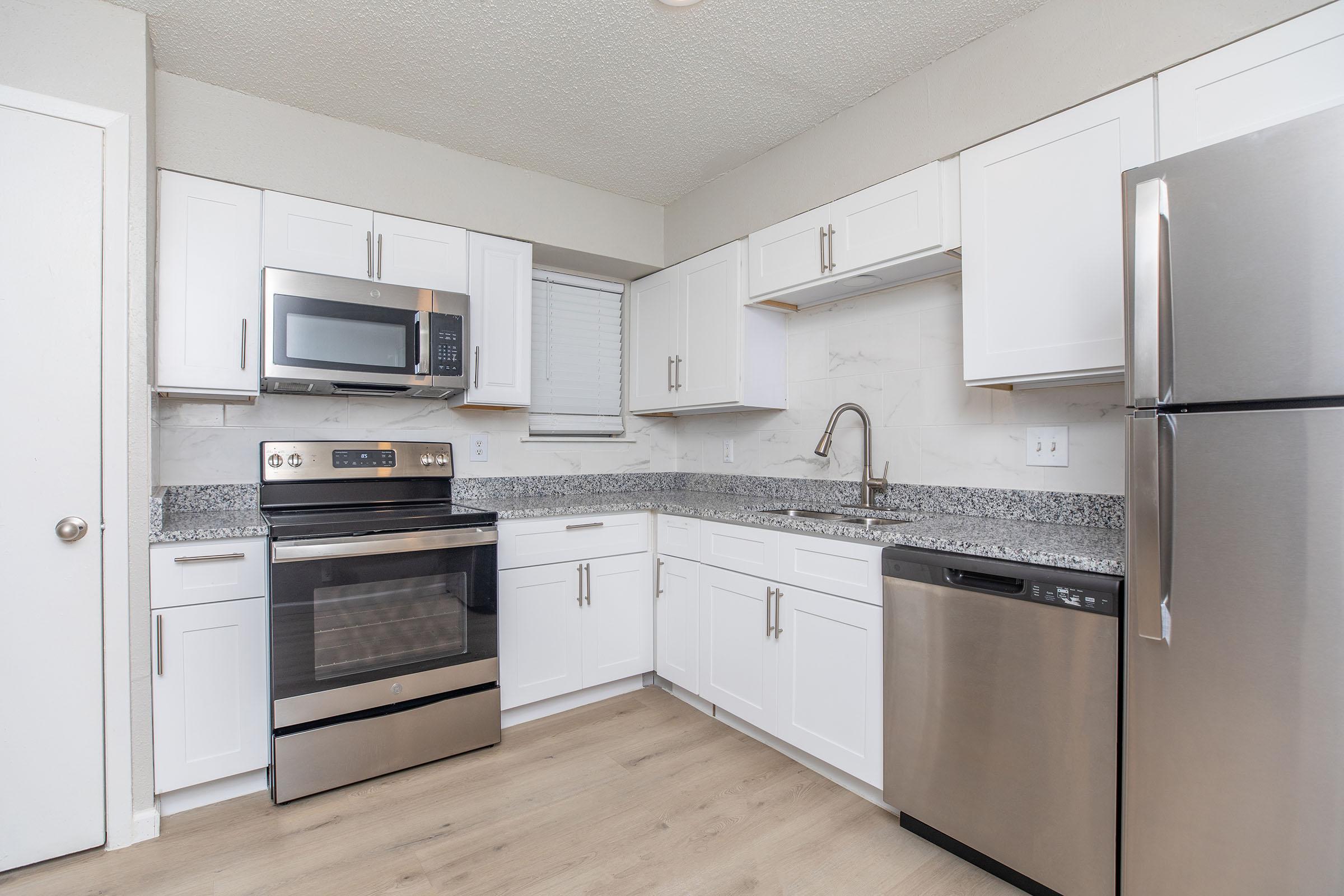 a kitchen with a stove and a refrigerator